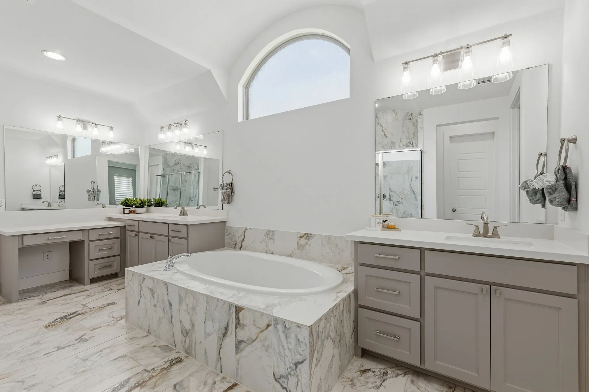 Soaking tub with a marbled surround and matching flooring