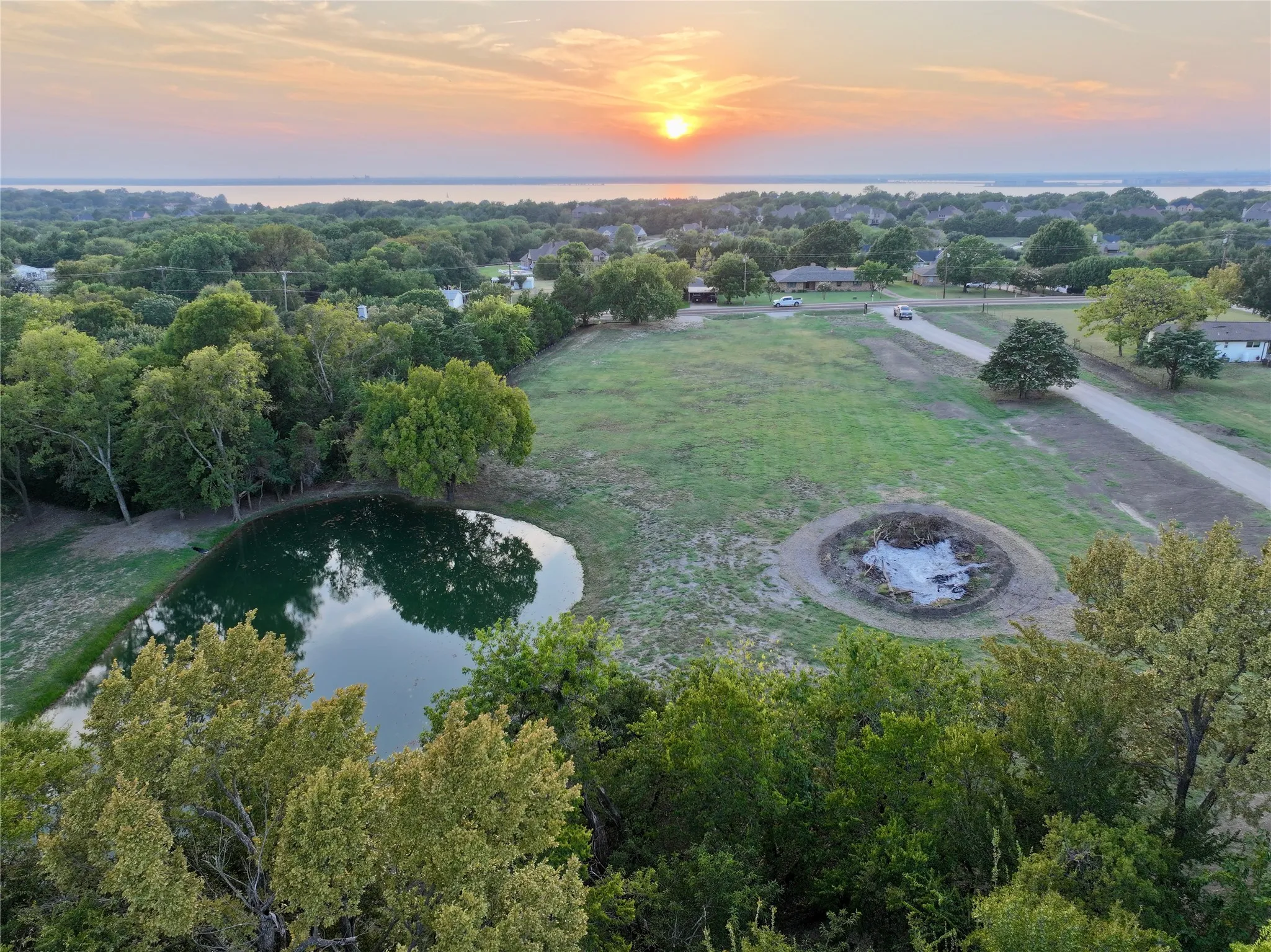 Aerial view at dusk of a water view and view of trees