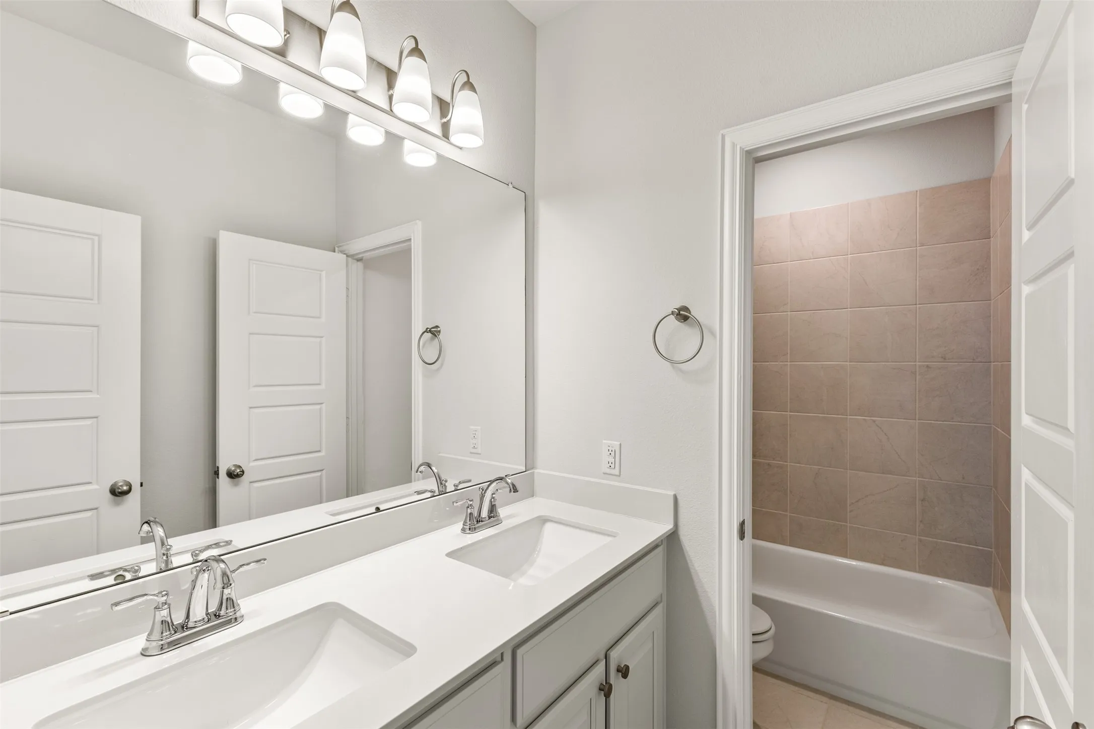 Dual vanity with integrated sinks and chrome fixtures