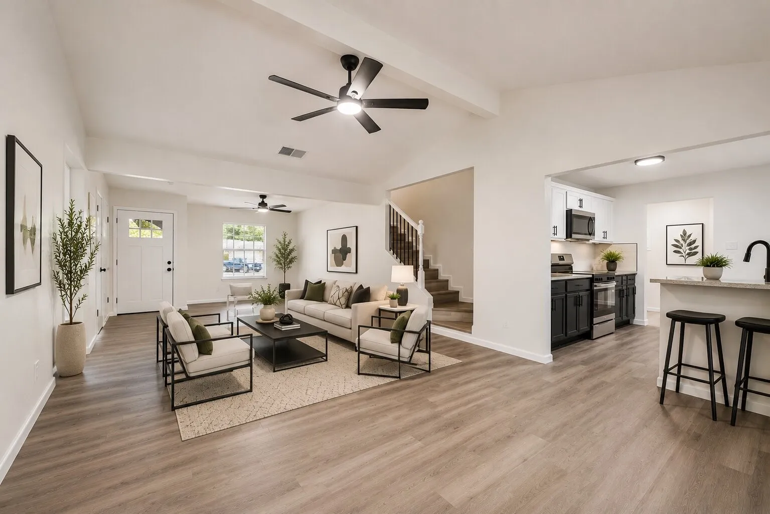 "Virtually Staged" Expansive living area featuring wood-finish flooring, recessed lighting, and a modern ceiling fan