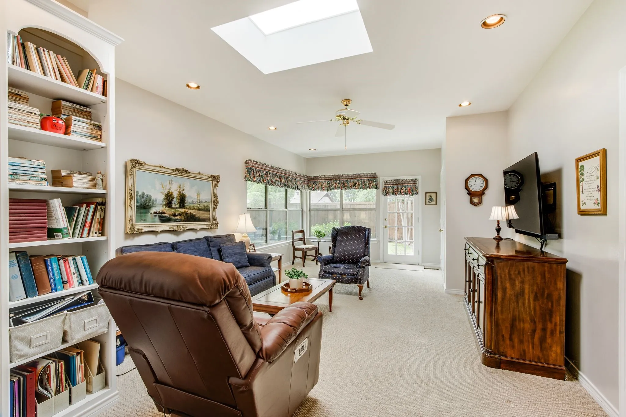 Bright living space with a ceiling skylight and recessed lighting