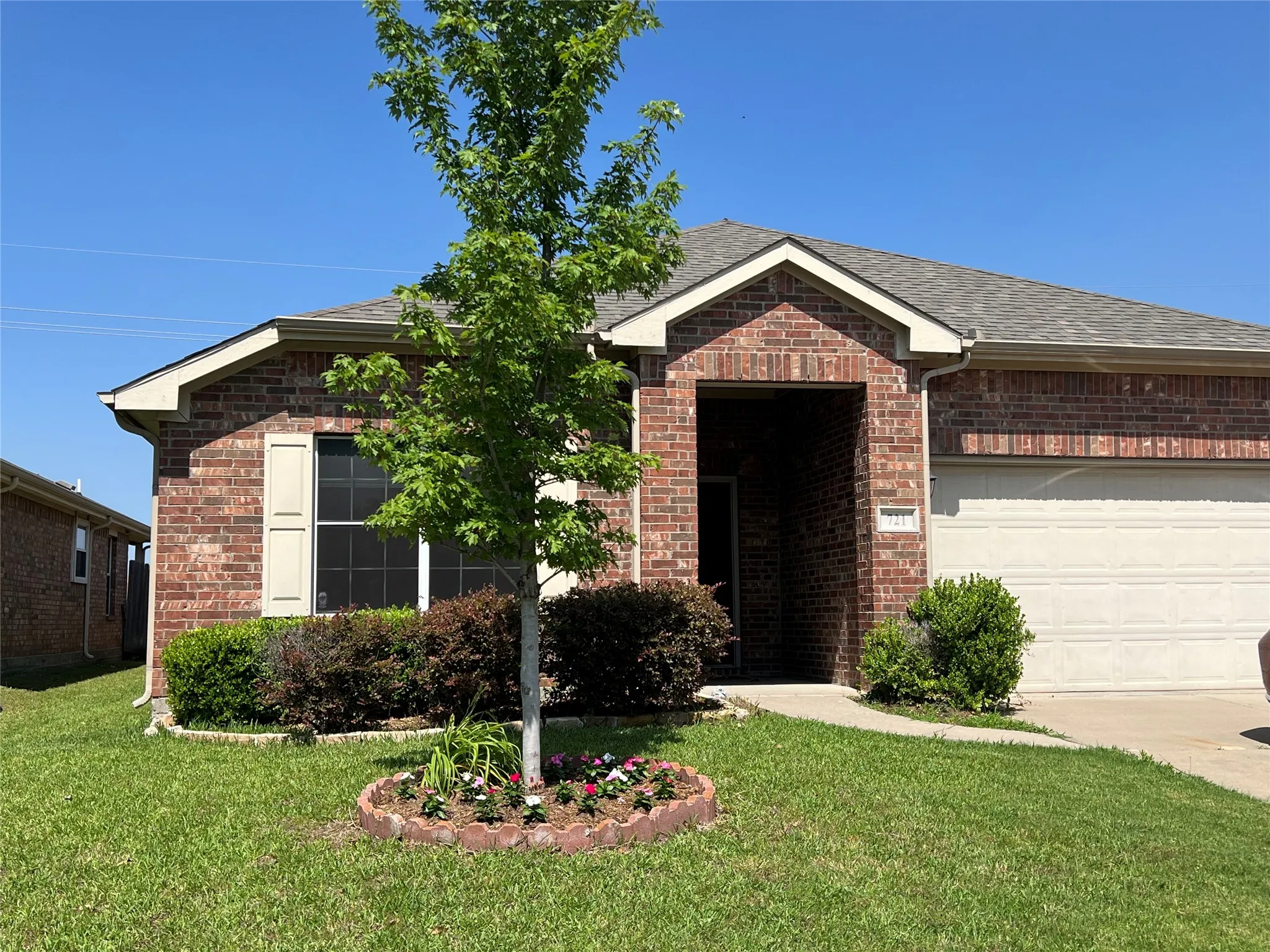 View of front of house with a front lawn and a garage