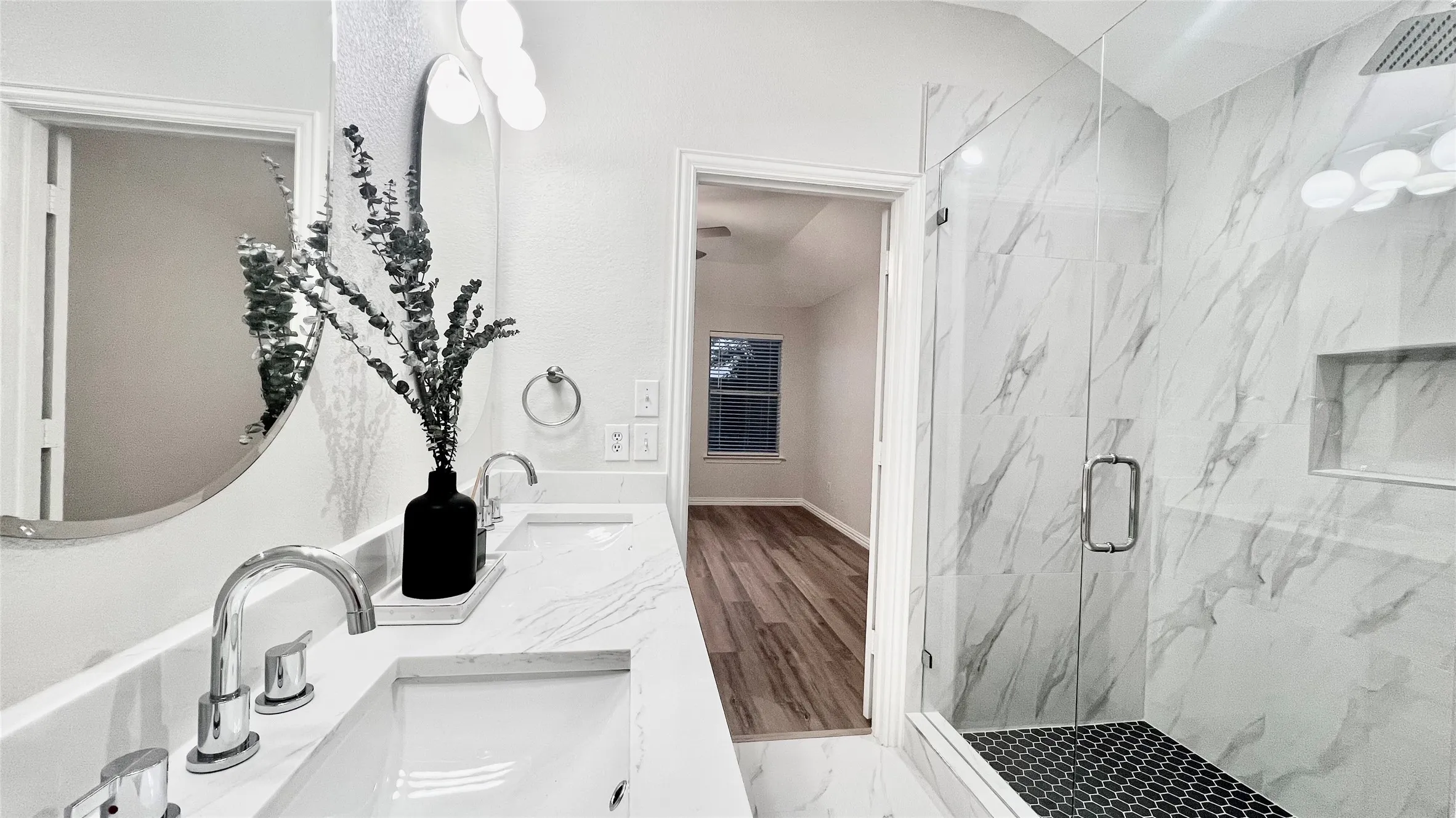 Dual vanity featuring rectangular undermount sinks and chrome fixtures
