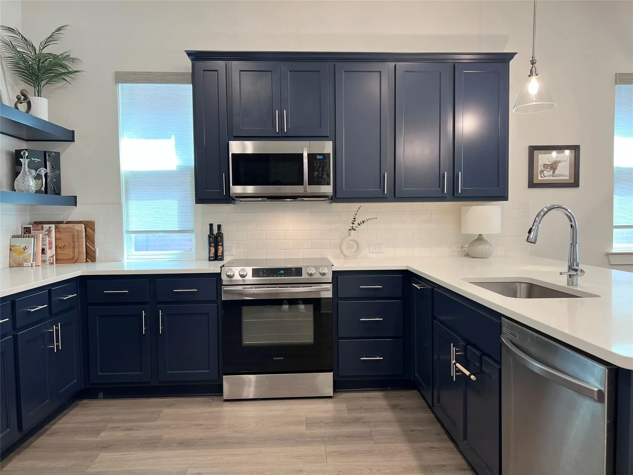 Kitchen with stainless steel appliances, sink, tasteful backsplash