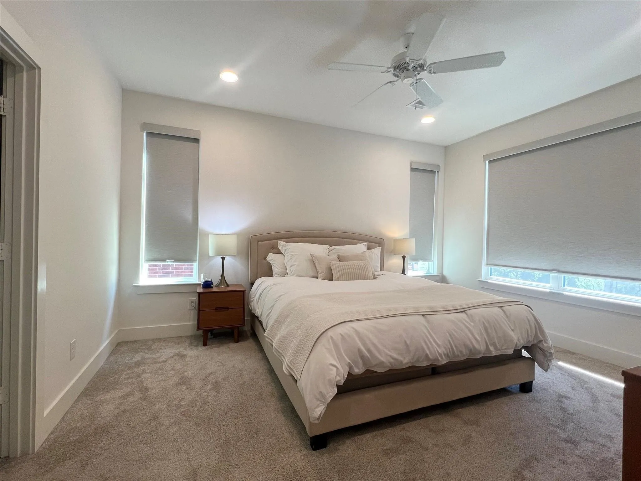 Primary Bedroom on second floor with multiple windows, ceiling fan, and carpet floors