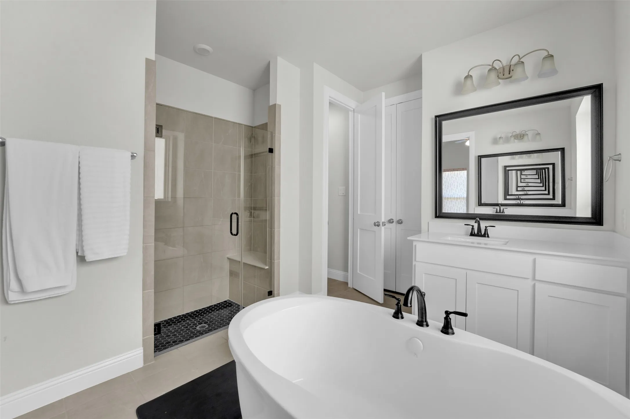 Freestanding soaking tub with matte black fixtures