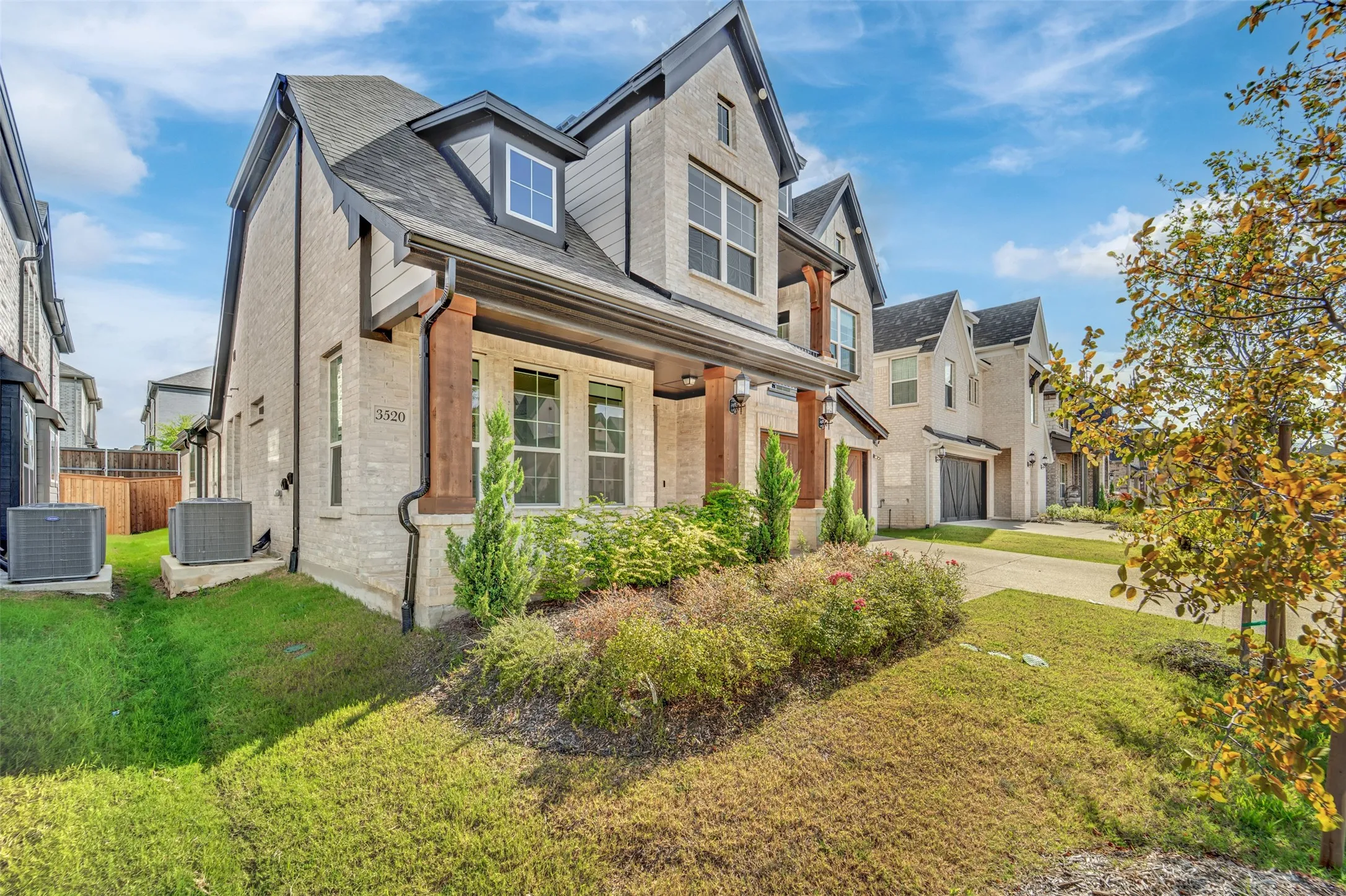 Modern traditional-style residence featuring light-colored brick and dark trim