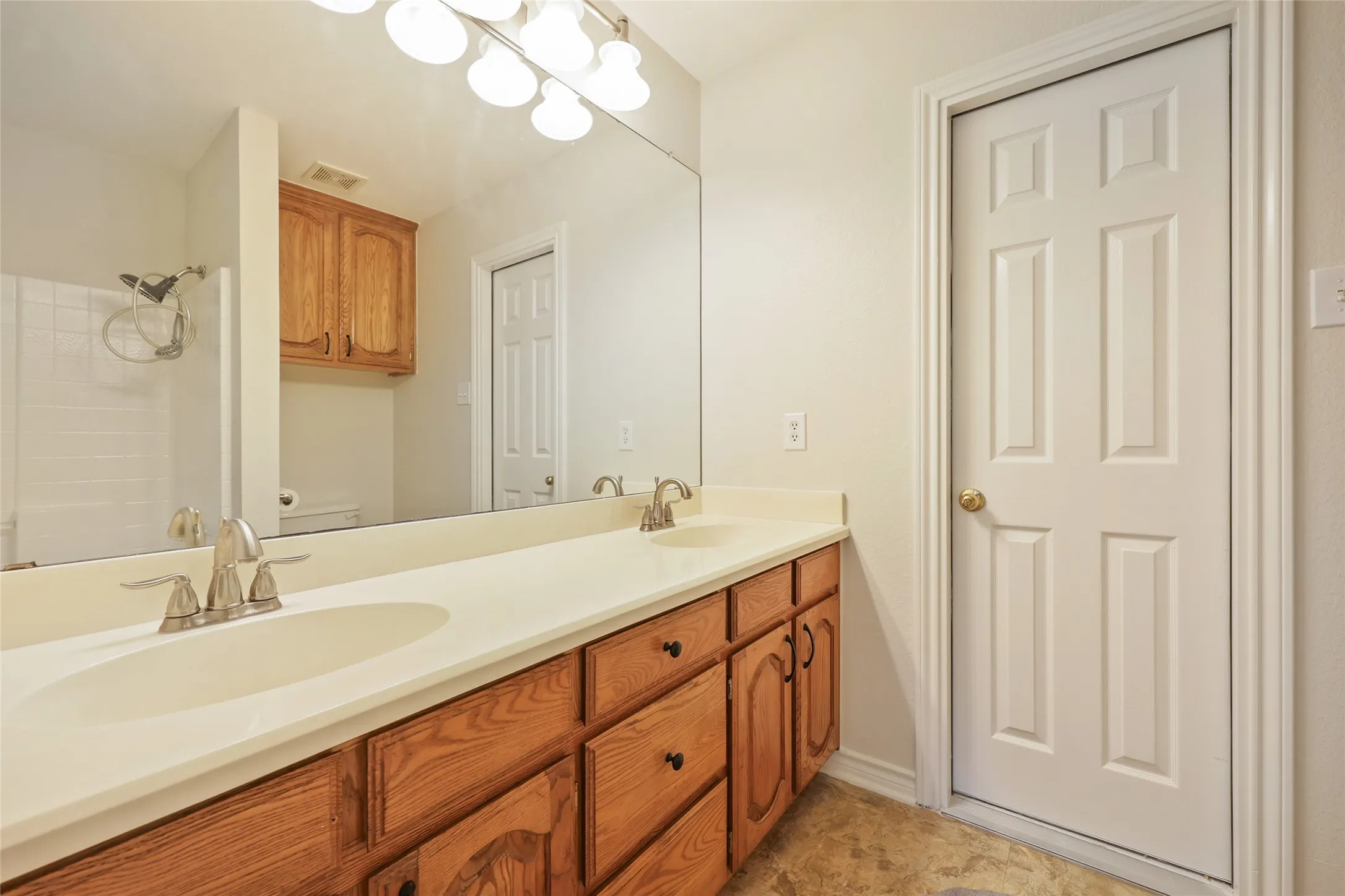 Double vanity with integrated sinks and chrome fixtures