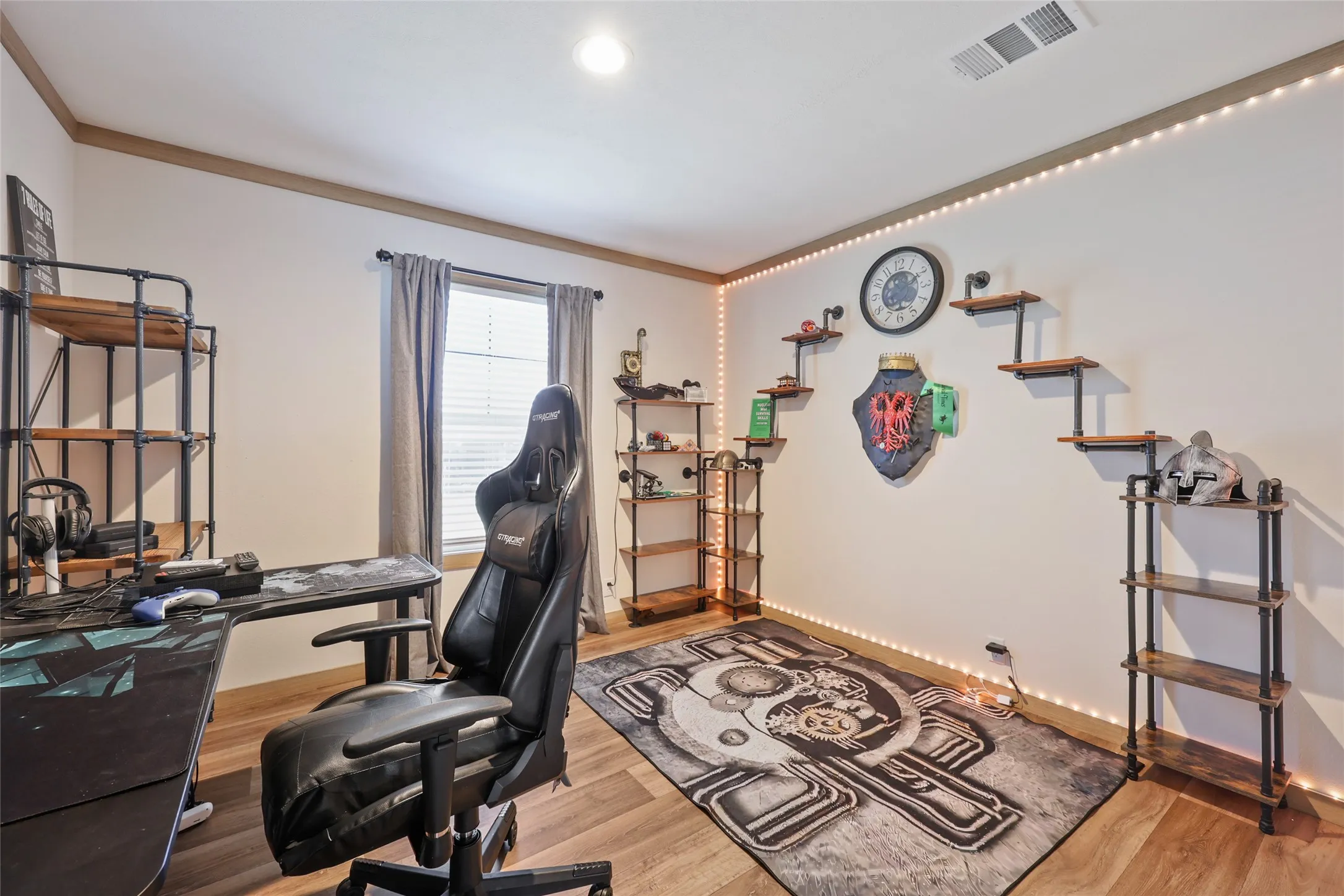 Interior room featuring wood-finish flooring, white walls, and a single window with blinds