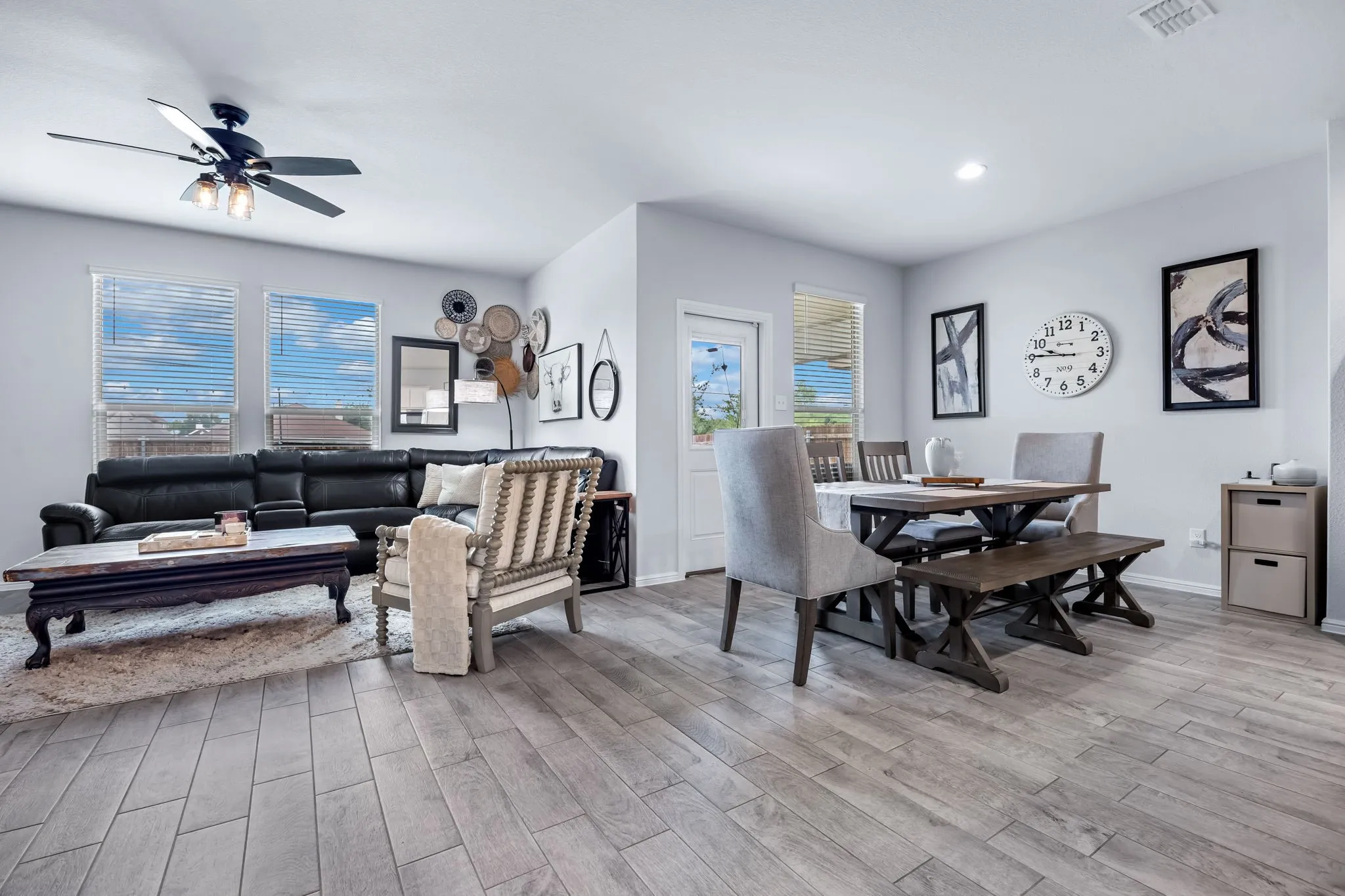 Open-concept living and dining area featuring wood-finish flooring