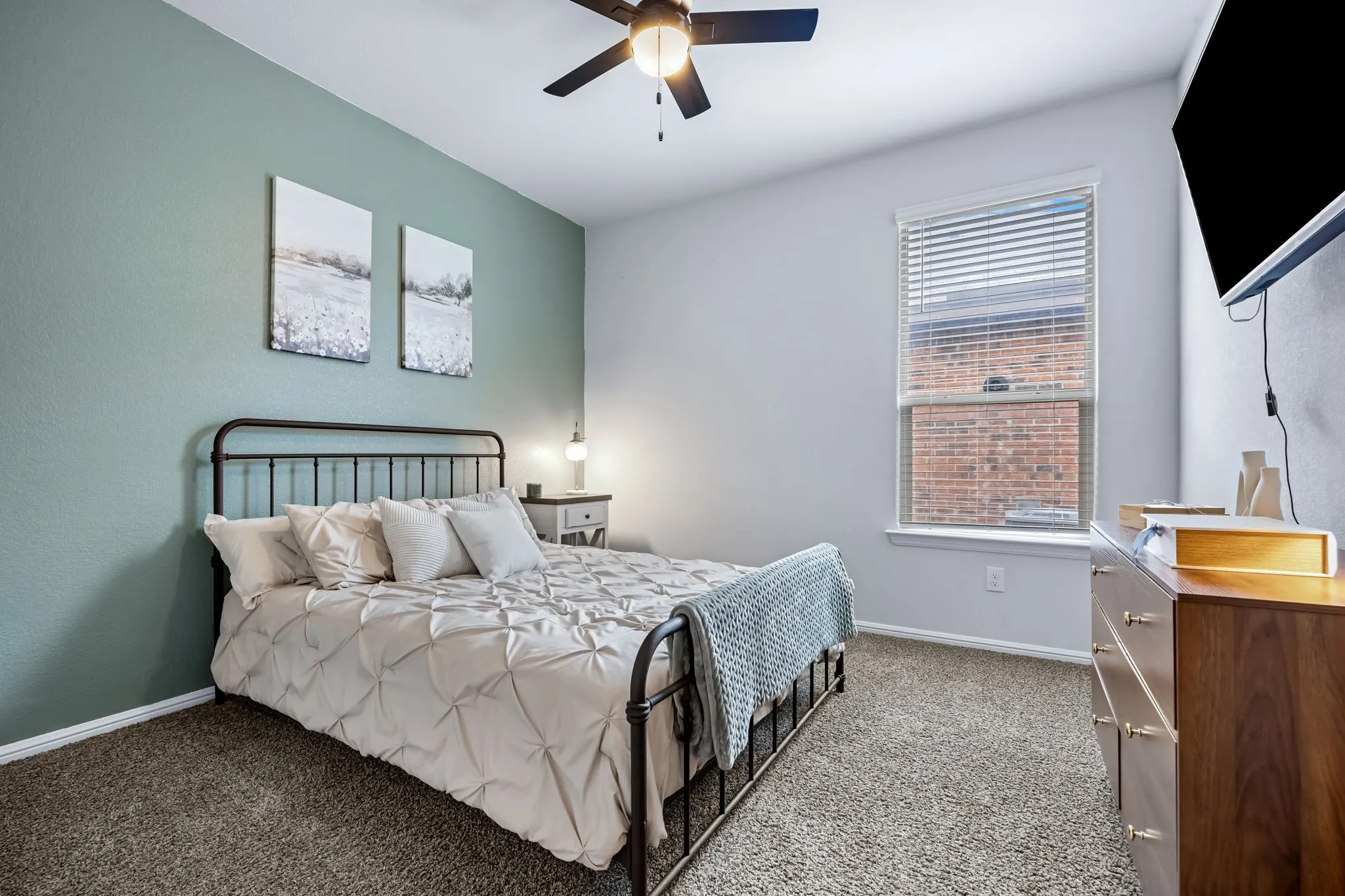 Bedroom featuring a ceiling fan, window with blinds, and carpeted flooring