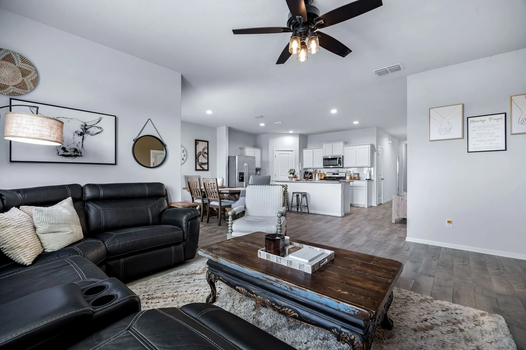 Open-concept living area featuring wood-finish flooring, recessed lighting, and a contemporary ceiling fan