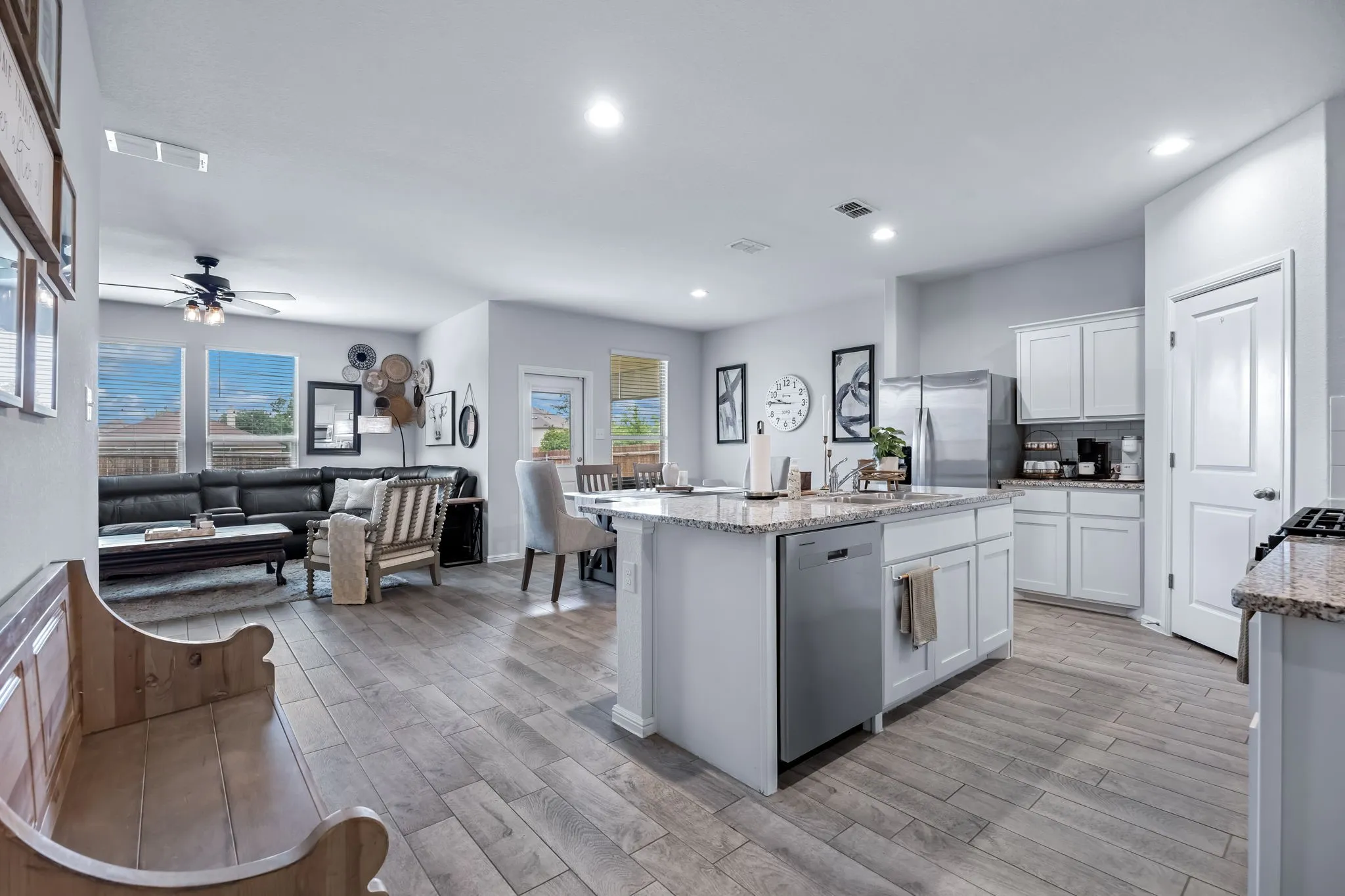 Open-concept interior featuring wood-finish flooring, recessed lighting, and a ceiling fan