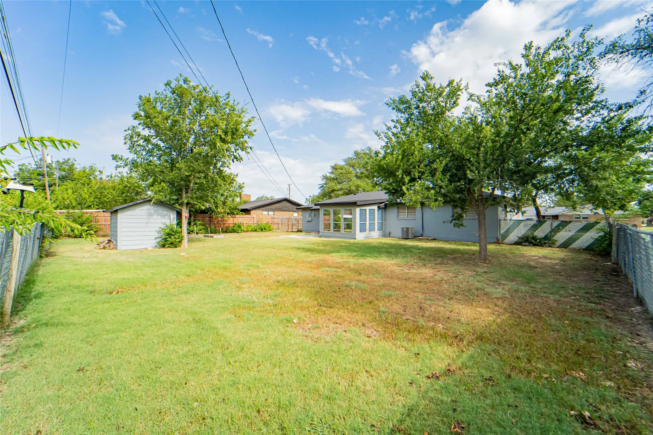 Lots of space in this backyard! Grill out, entertain guests or just relax under these mature shade trees!