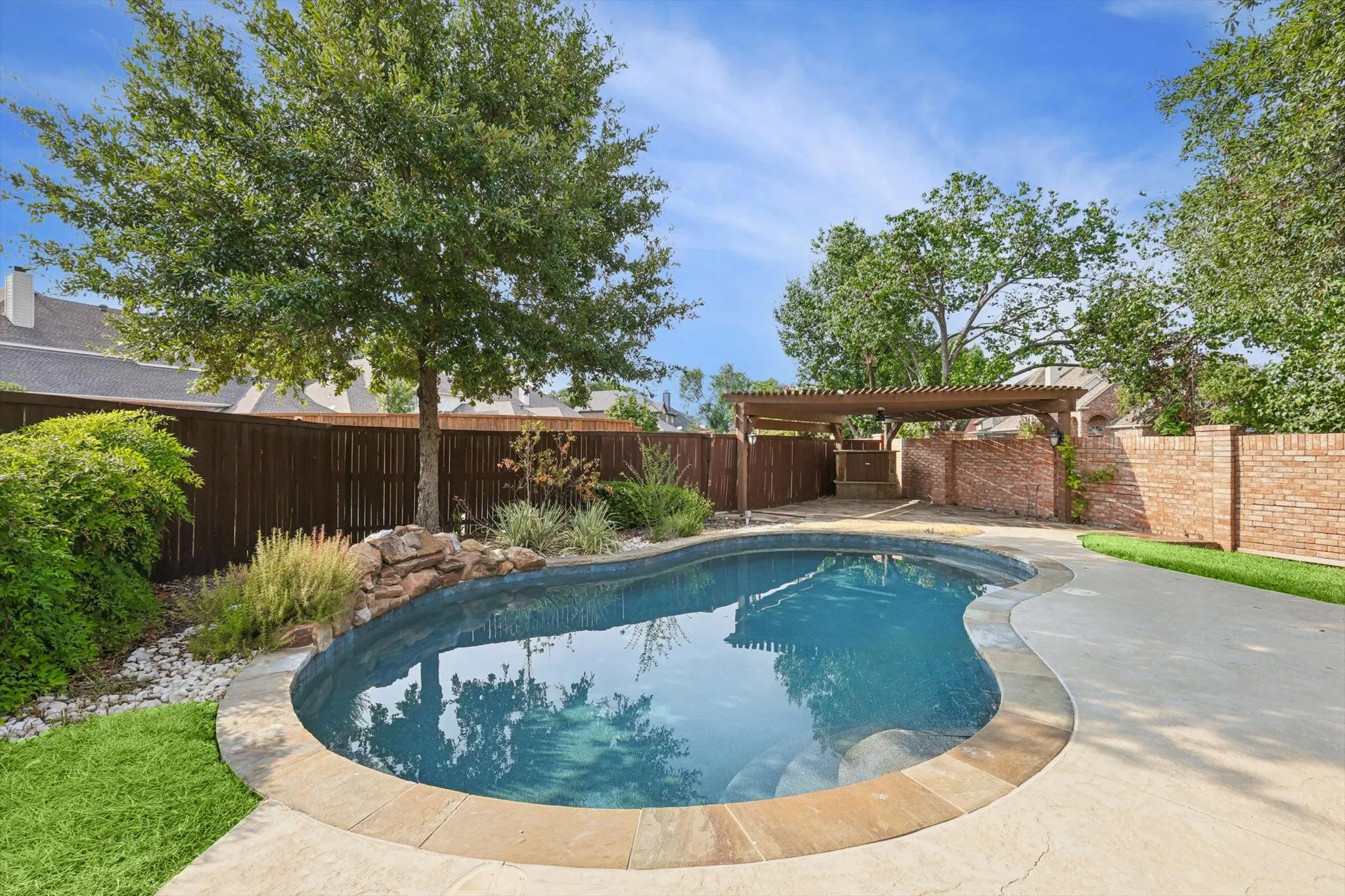 View of swimming pool with a pergola