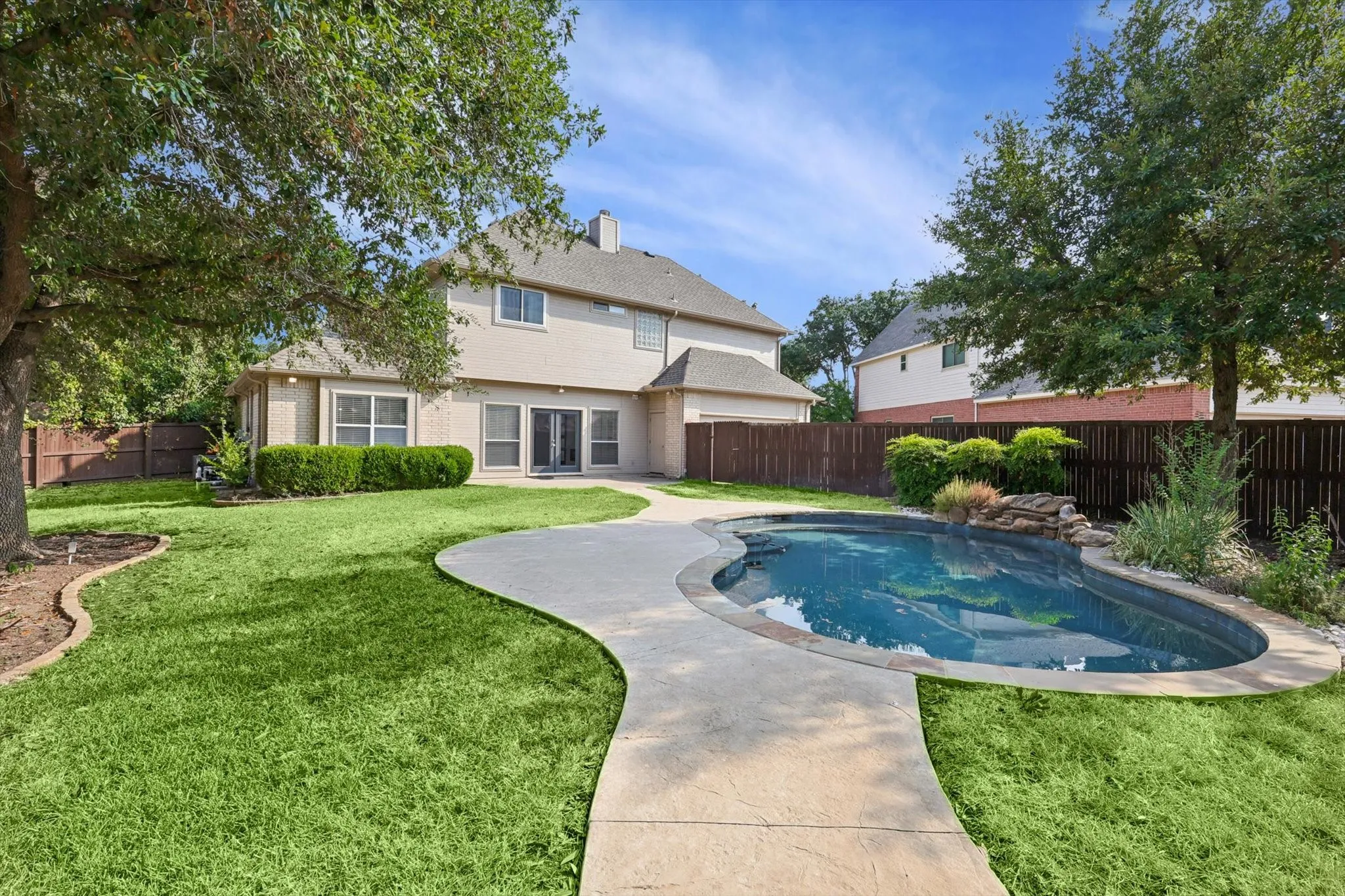 View of swimming pool with a yard
