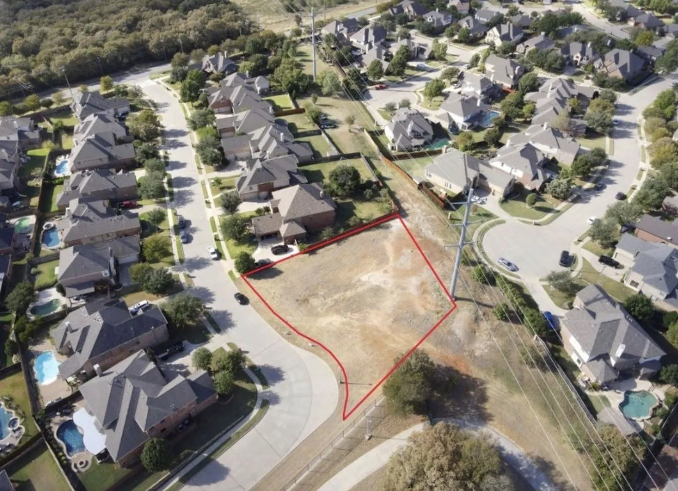 Expansive vacant lot situated within a developed residential area