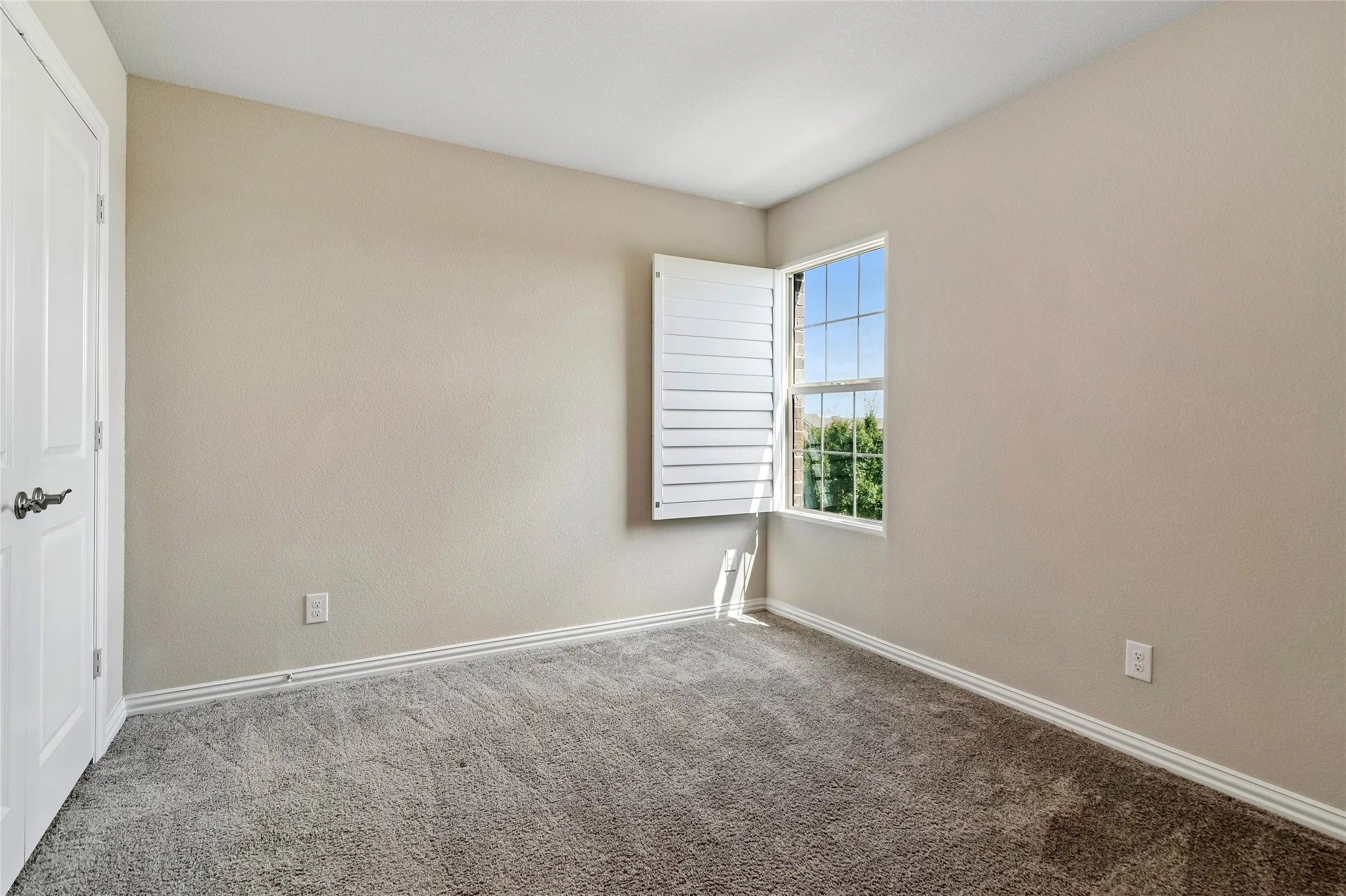 Guest bedroom views greenbelt out front.