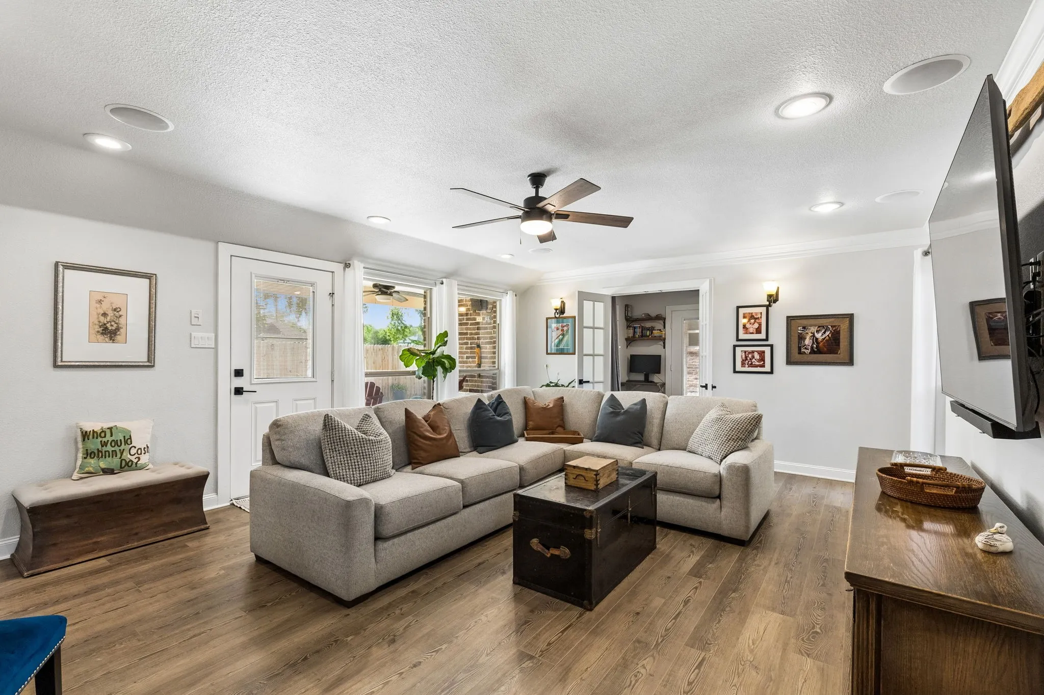Spacious living area featuring wood-finish flooring, recessed lighting, and a ceiling fan
