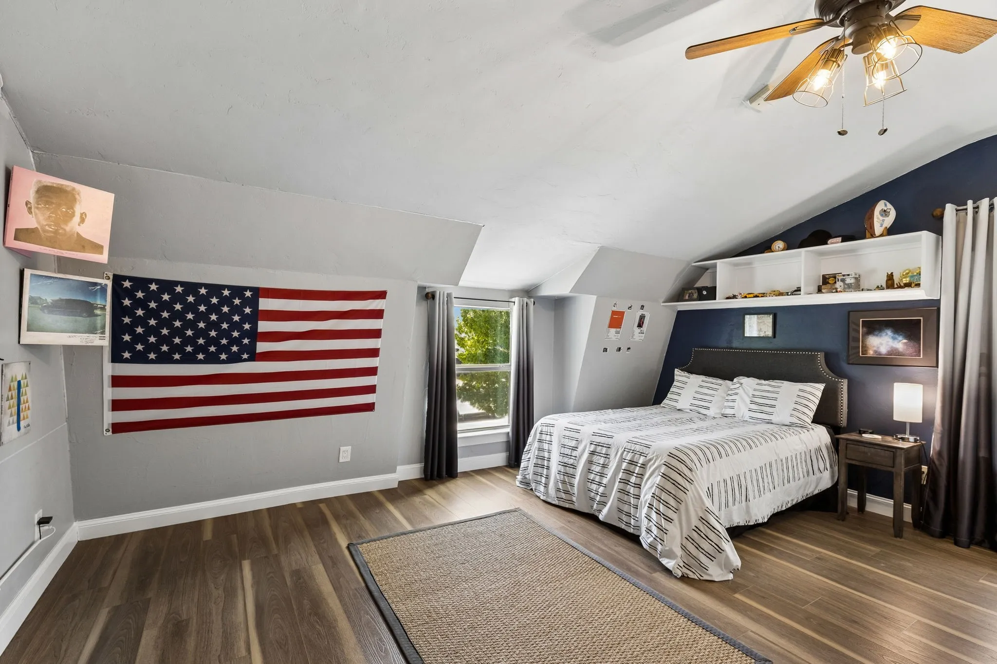 Secondary Bedroom featuring wood-finish flooring, a pitched ceiling, and recessed window