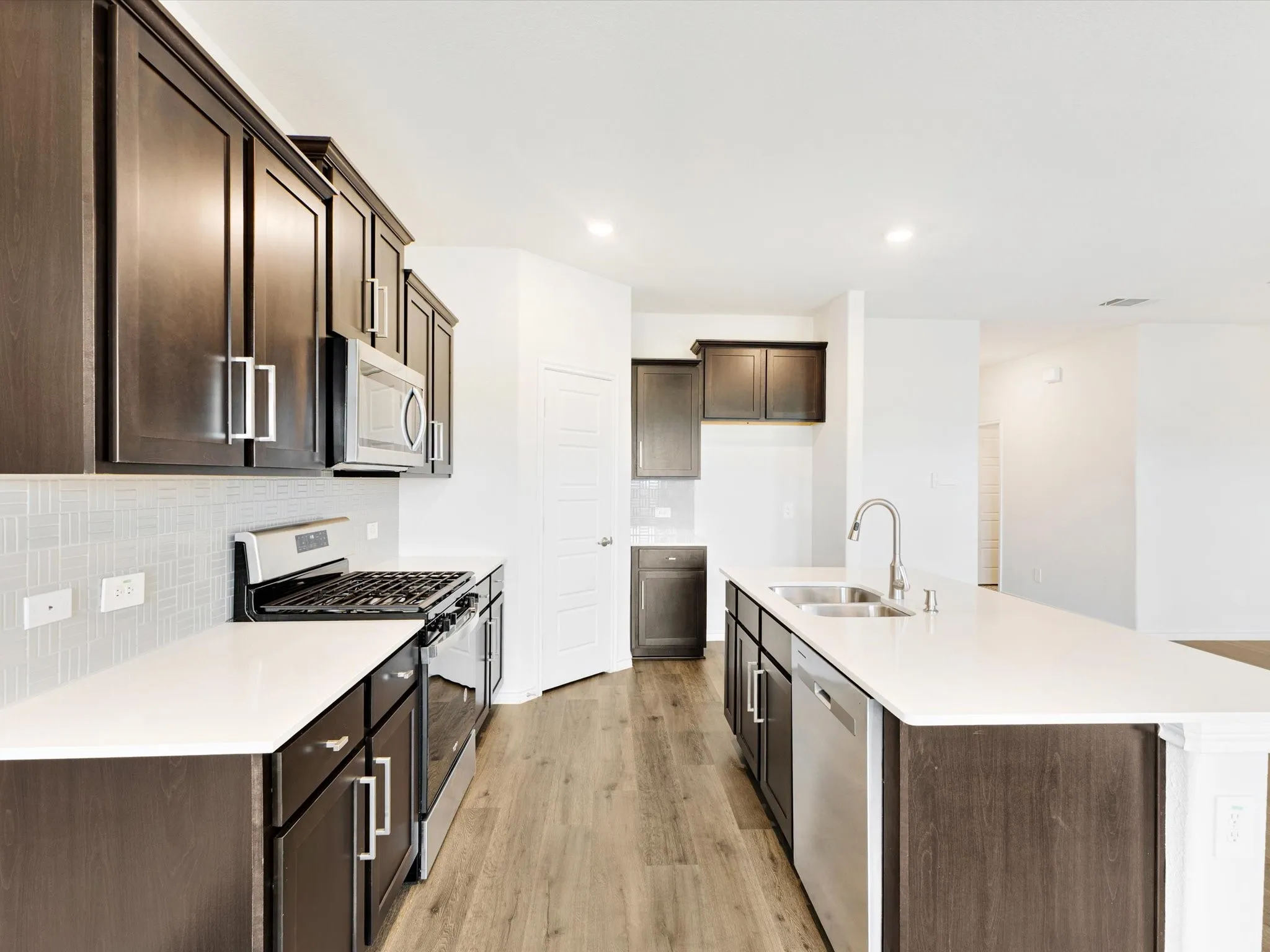 Spacious kitchen with abundant cabinetry and generous prep space.