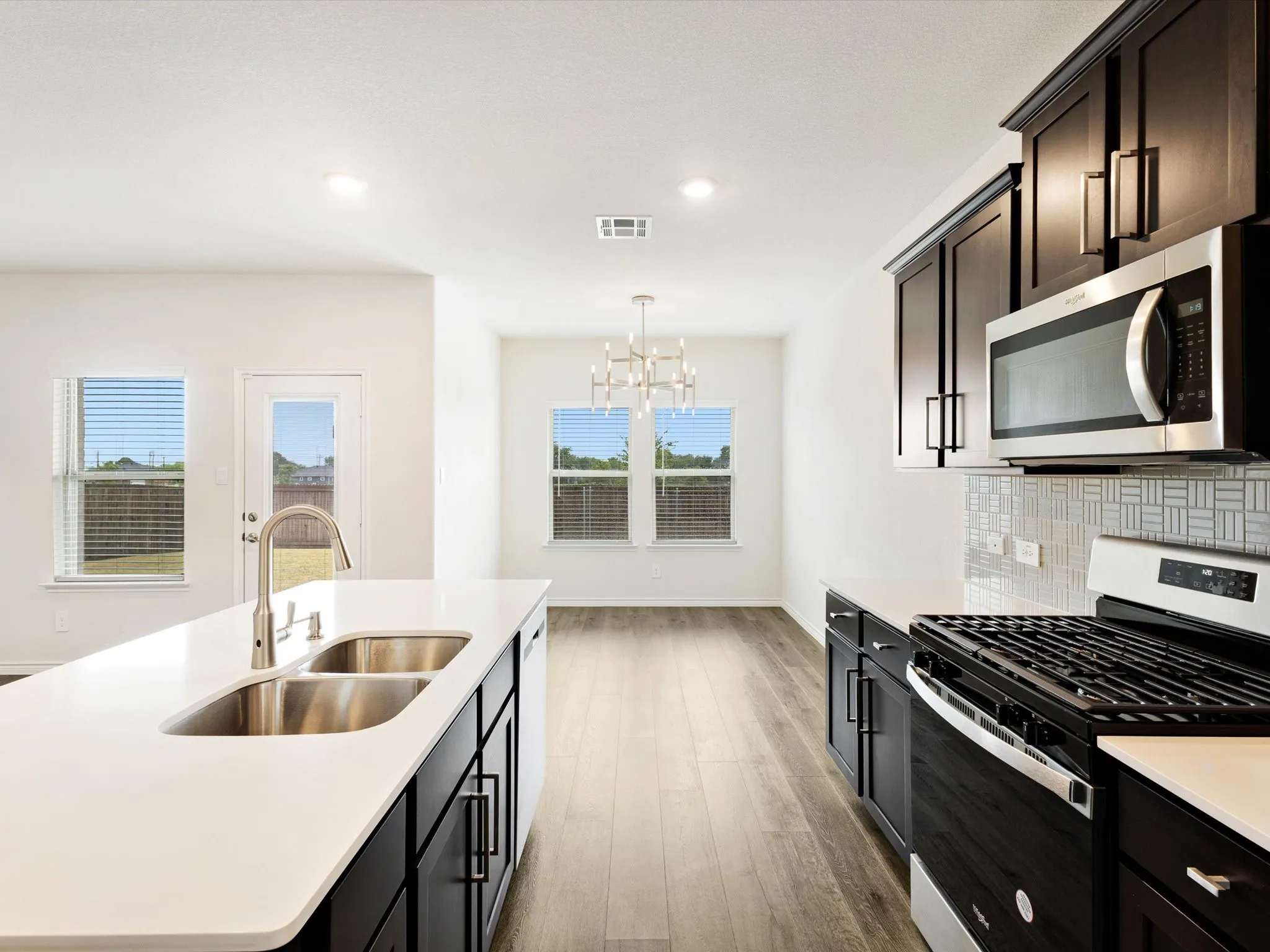 Center island overlooks the open living and dining areas, ideal for entertaining
