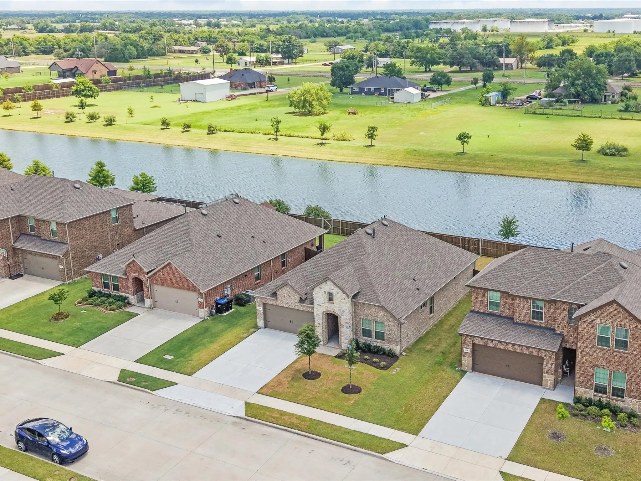 Aerial view highlighting the home's proximity to the neighborhood pond
