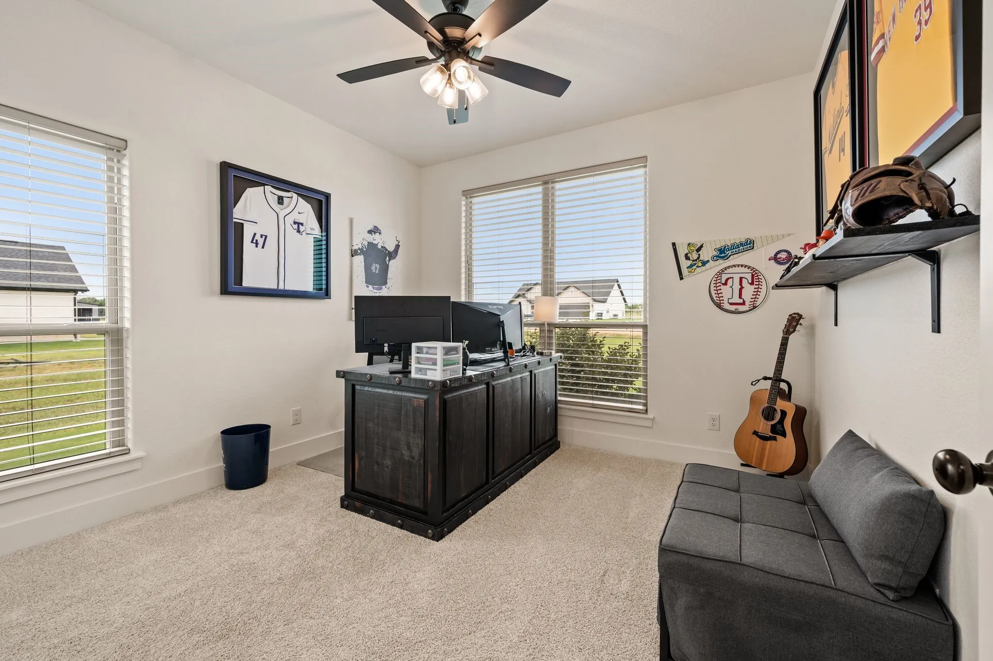 Bright interior room featuring neutral carpet, white walls, and a ceiling fan with integrated lighting