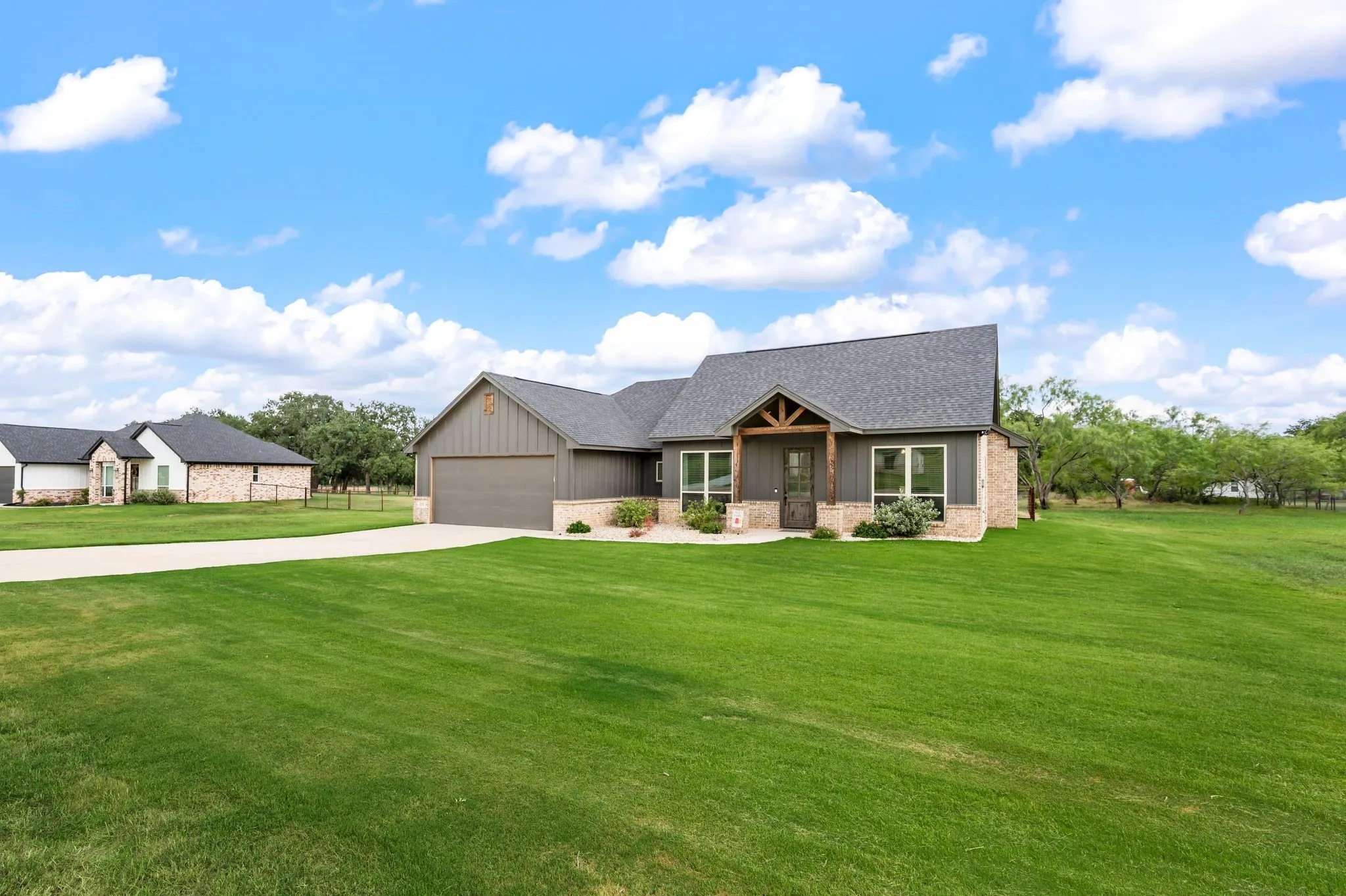 Modern farmhouse exterior with board and batten siding and stone accents