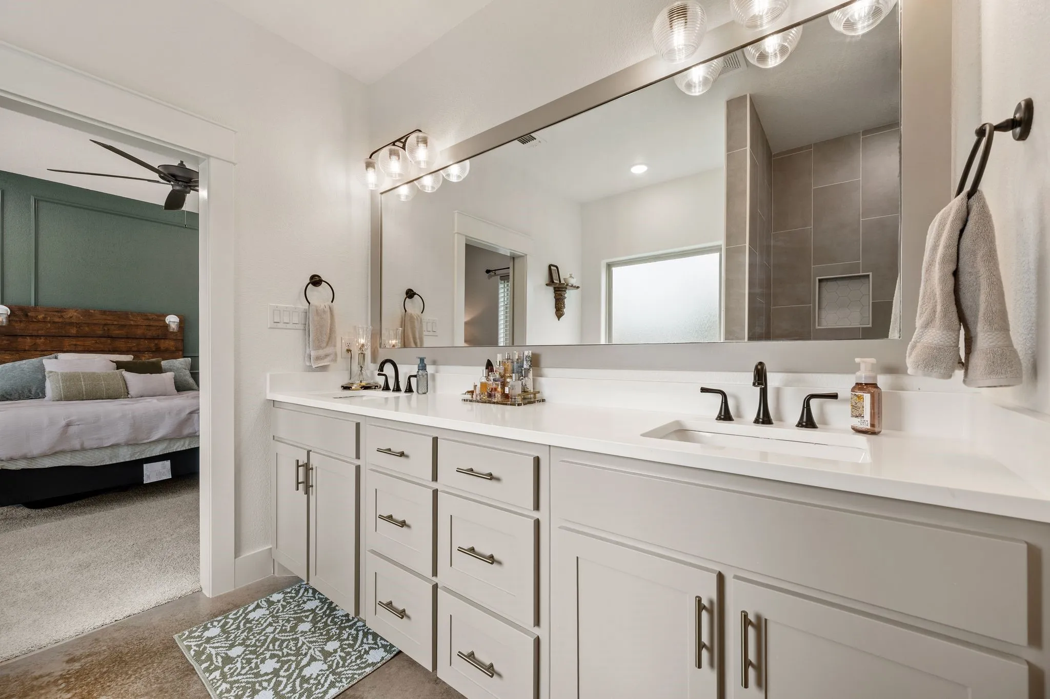 Dual vanity with light gray cabinetry, white countertops, and matte black fixtures