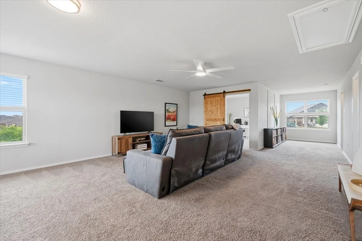 A large upstairs flex room built for movie nights, a play area, or a second living space.