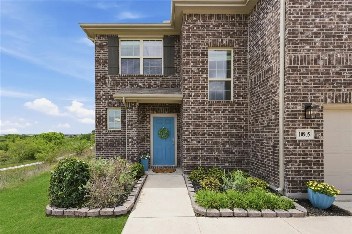 Welcoming entryway features an inviting blue door for a modern touch.