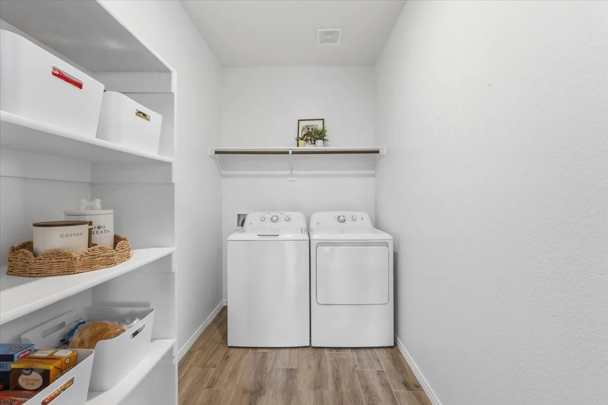 Oversized pantry and  laundry room offers built-in storage and extra shelving