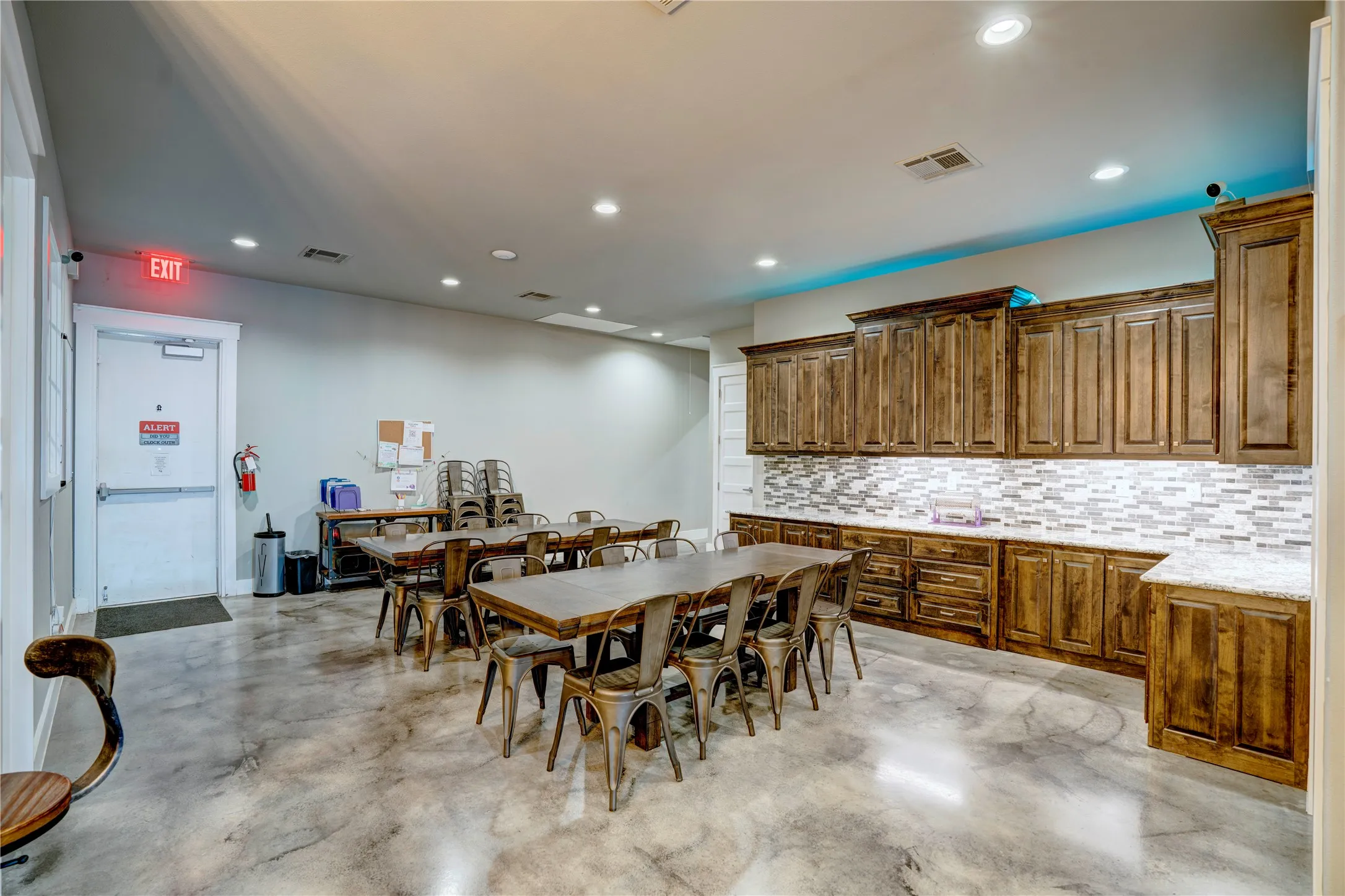 Spacious common area featuring stained concrete flooring and recessed lighting