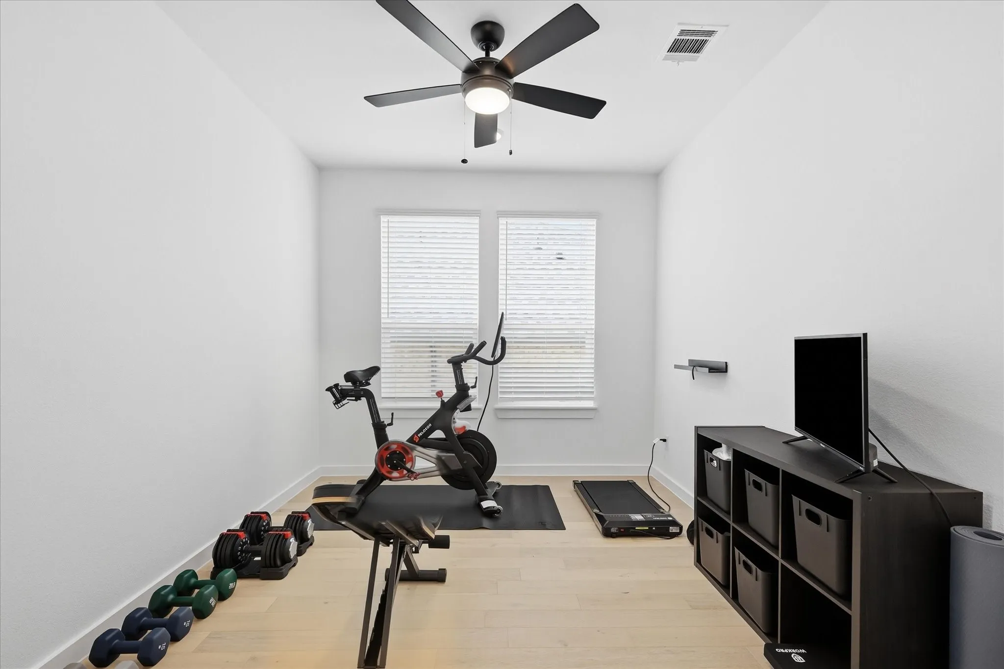 Potential office that is currently be used as an exercise room that  features wood flooring and window that offer abundant light.