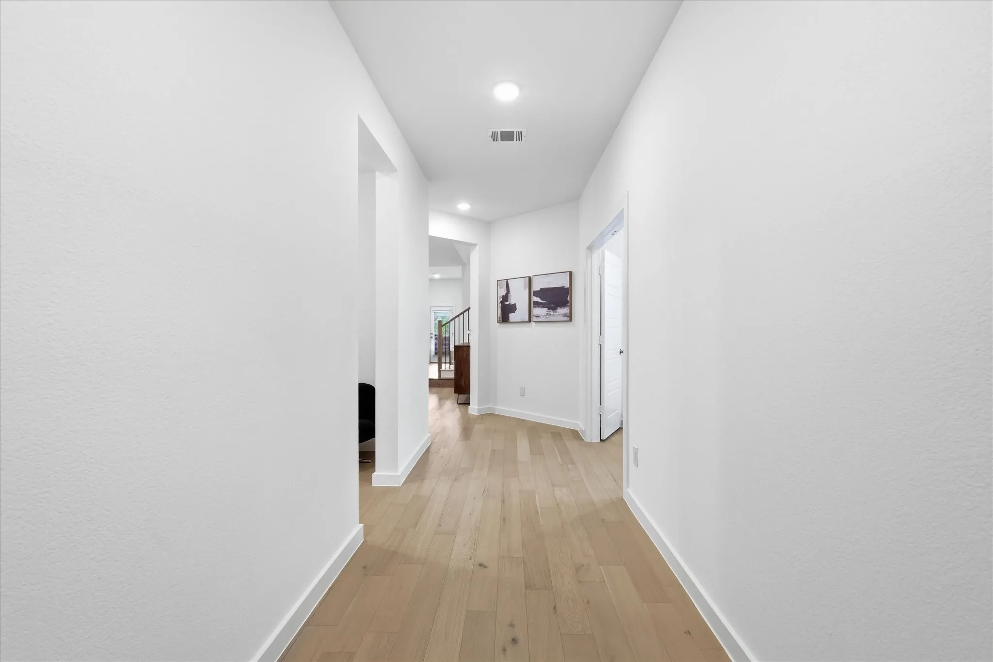 Entry hallway featuring light wood flooring.