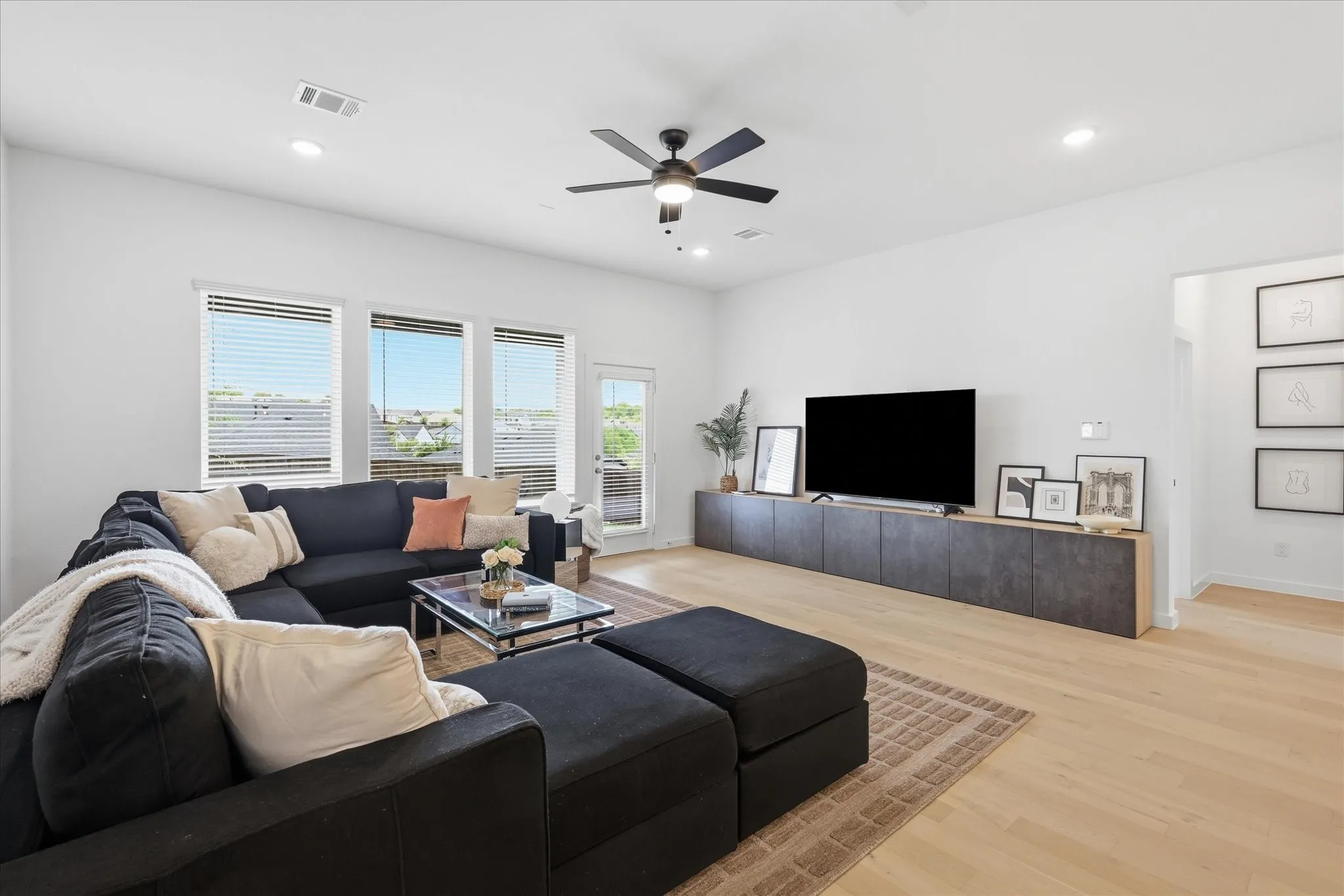 Spacious living area with abundant natural light coming from the multiple windows.