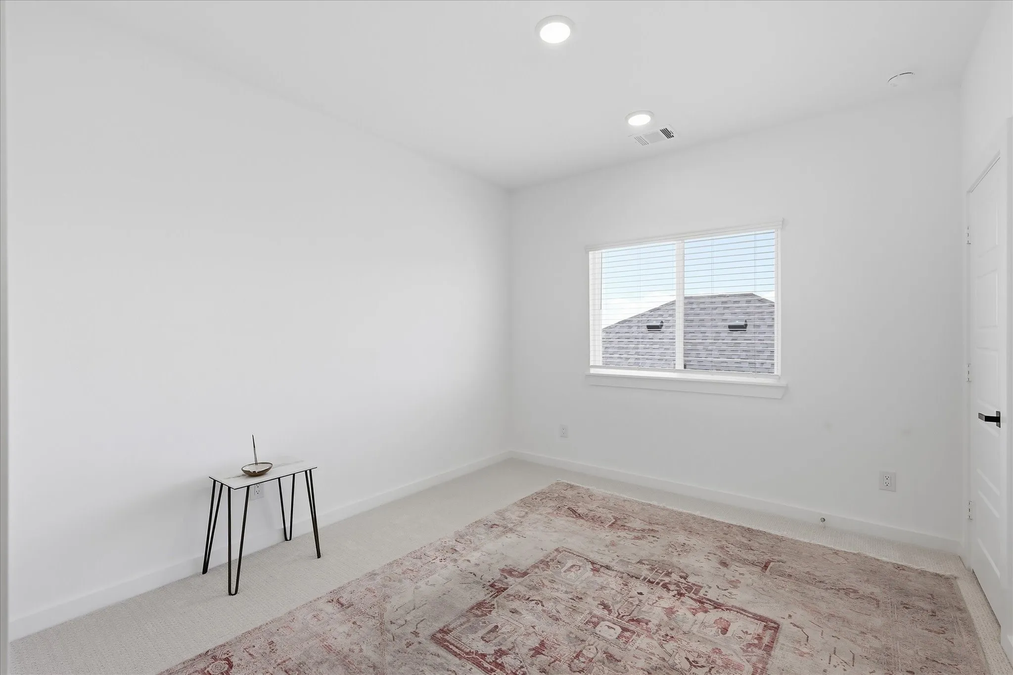 Upstairs bedroom that is flooded with natural light and currently being used as a yoga room.