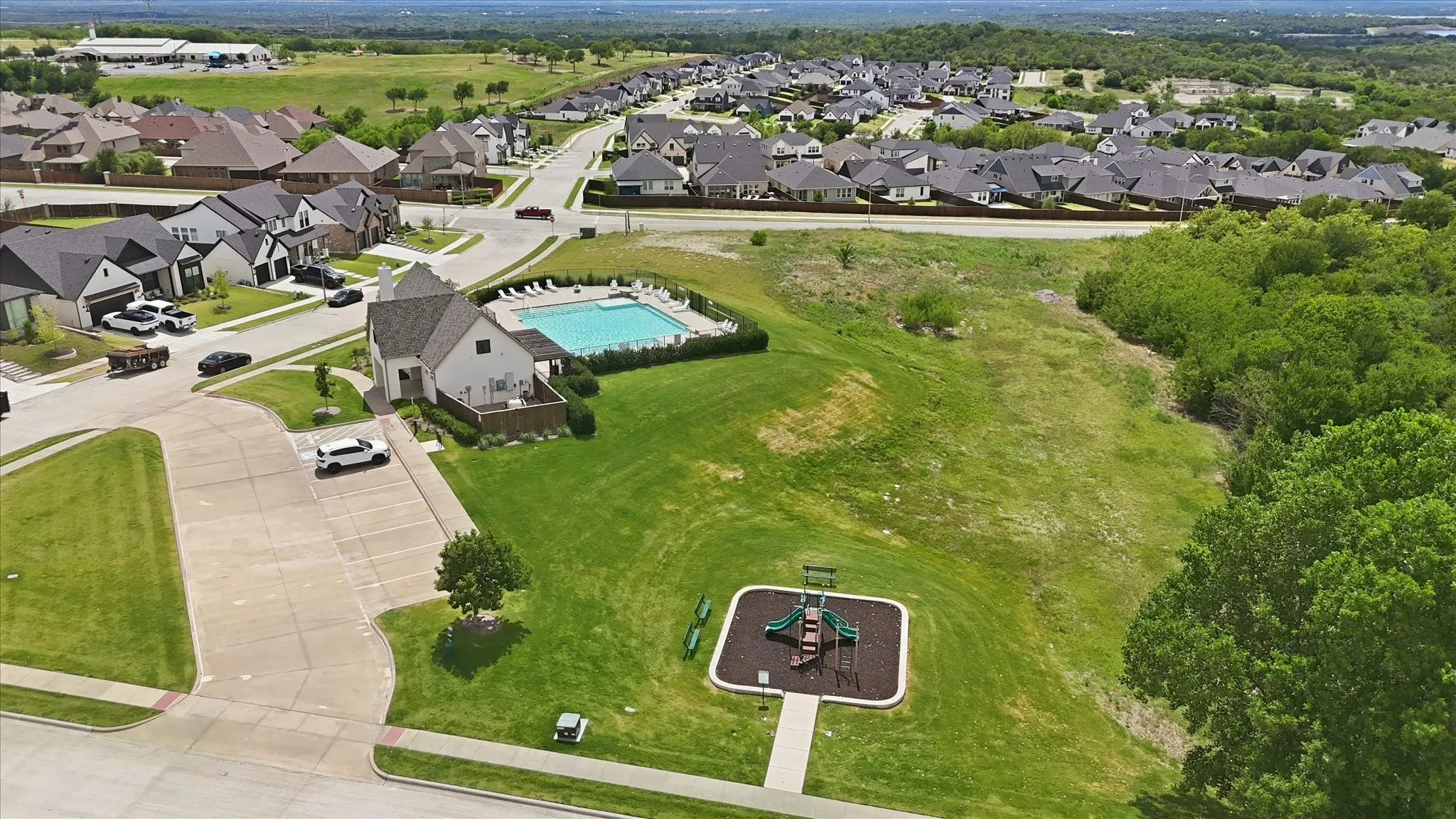 Community amenities featuring a swimming pool, clubhouse, and playground. The community also has plenty of green space.
