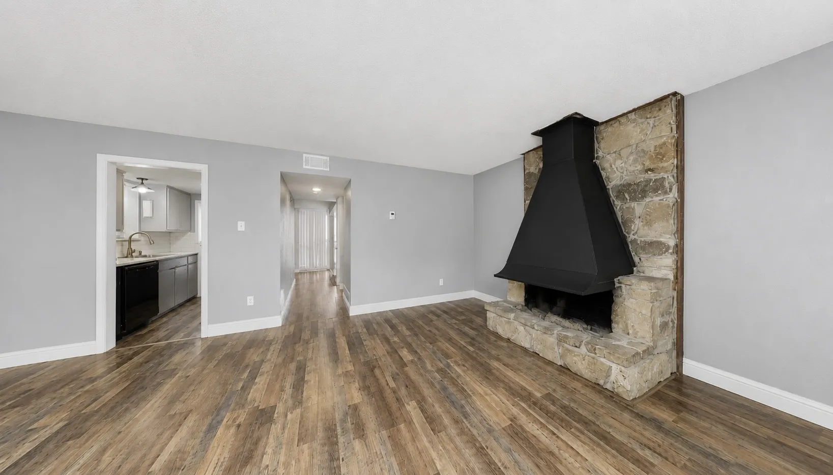 Living area featuring wood-finish flooring, light gray wall paint, and white baseboards