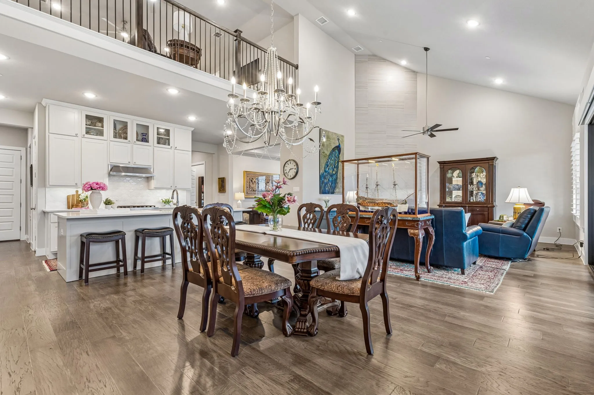 This thoughtfully designed custom home displays soaring ceilings, gorgeous hardwood floors, quartz countertops, plantation shutters, and solid-core doors throughout.