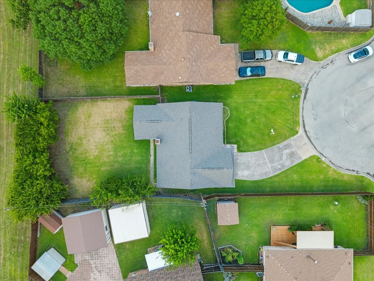 Single-story residence featuring a gray shingle roof and a concrete driveway