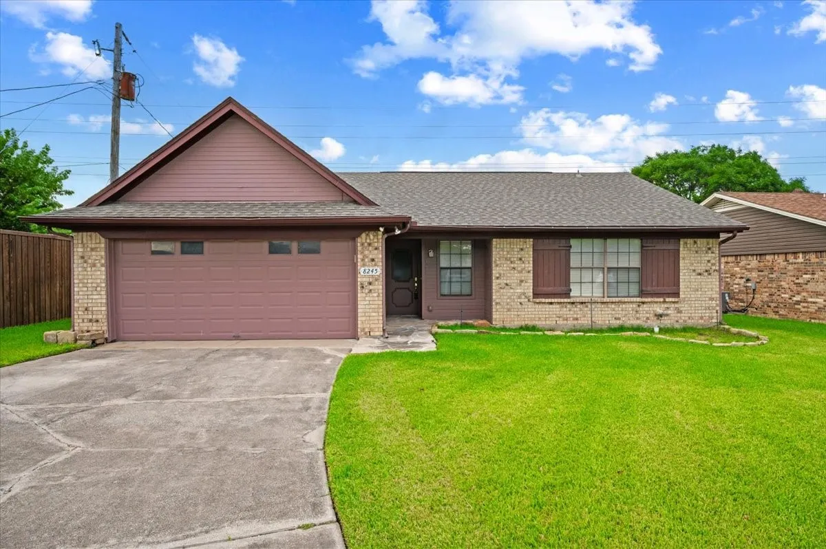 Brick facade home with a shingle roof