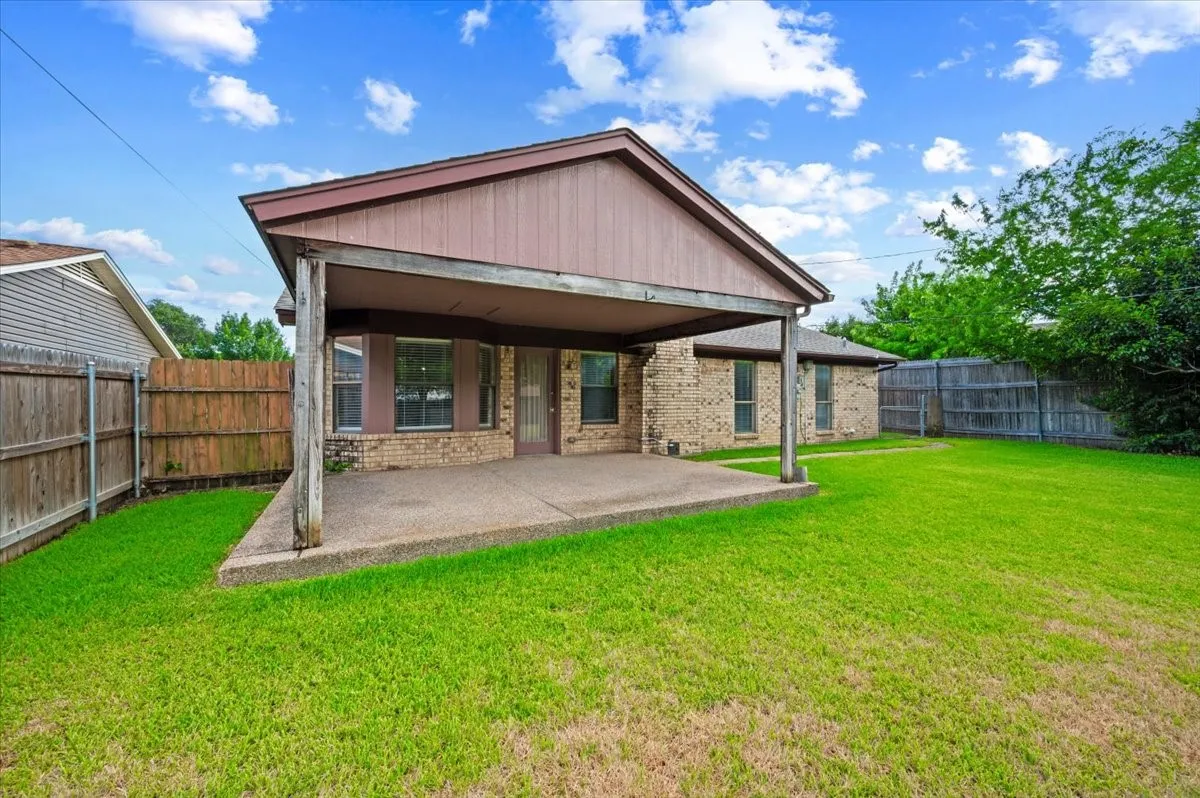 Expansive backyard with a covered concrete patio
