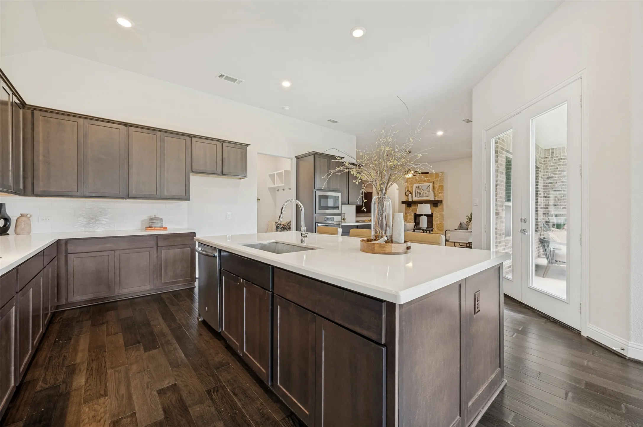 Chef-inspired kitchen with oversized island and direct access to the covered patio for effortless indoor-outdoor living.