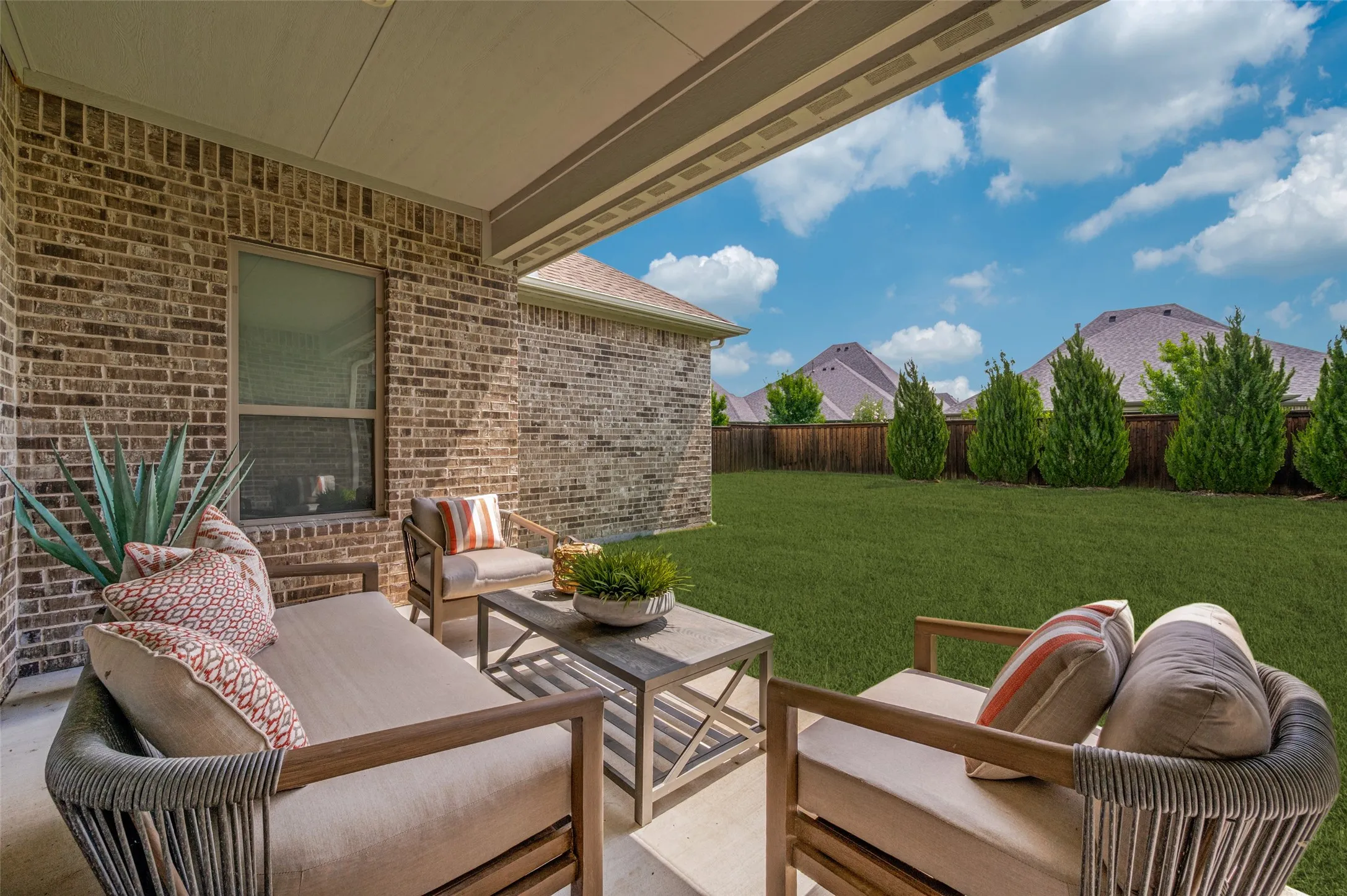 Covered back patio providing the perfect space for outdoor dining, relaxing, and entertaining.