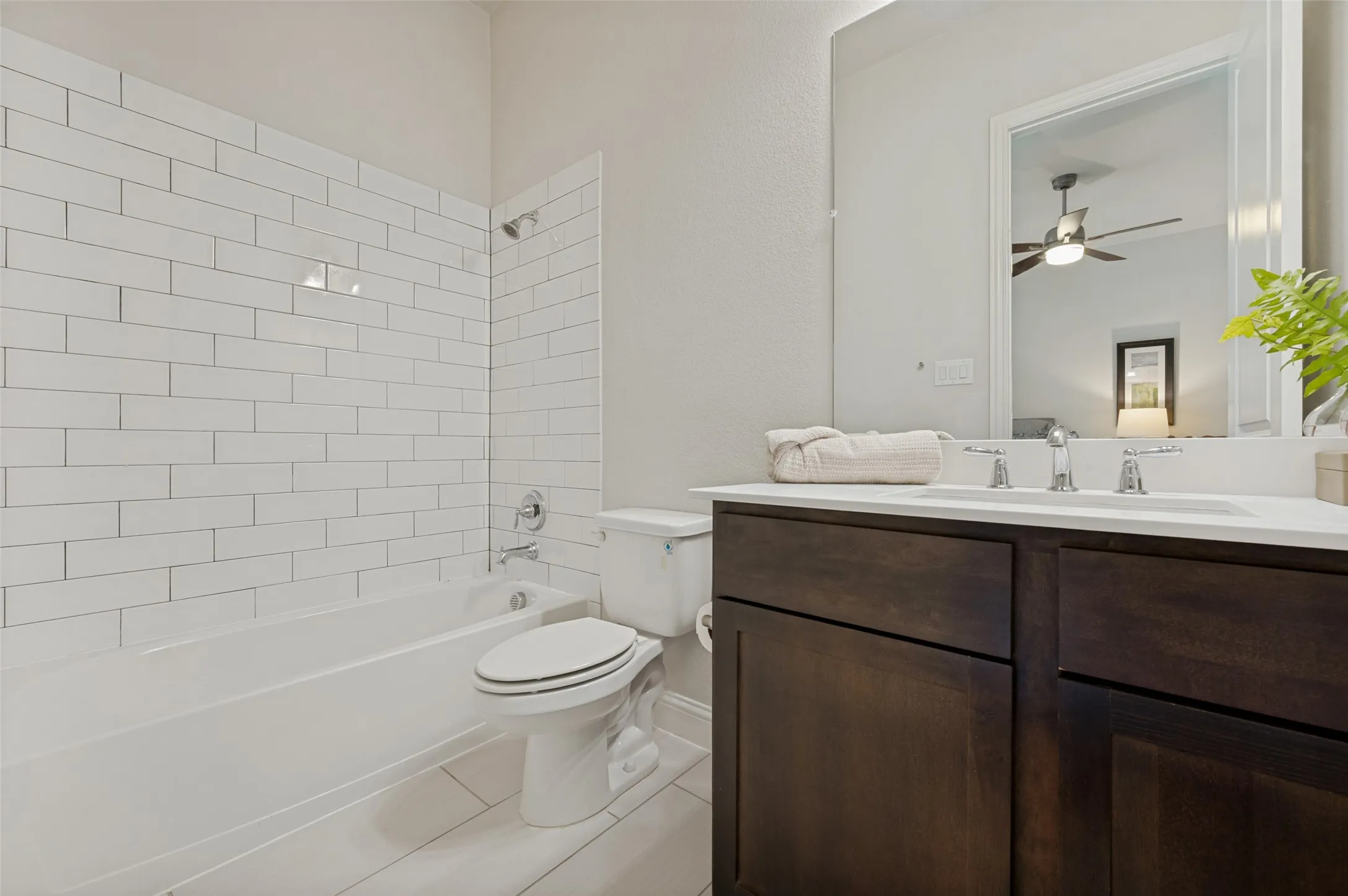 Secondary full bathroom featuring a tub-shower combination, subway tile surround, and modern finishes.