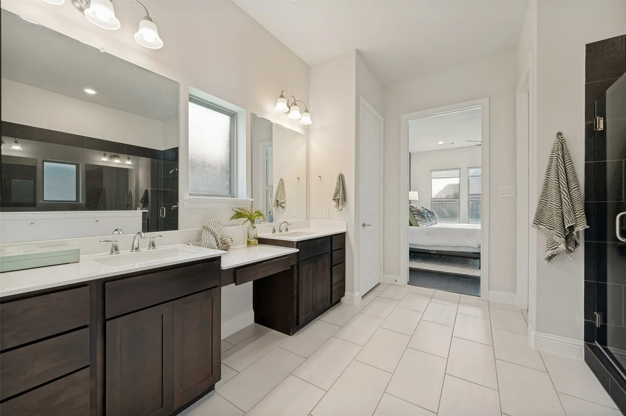 Luxurious owner's bath offering dual vanities, expansive counter space, and a functional open layout.