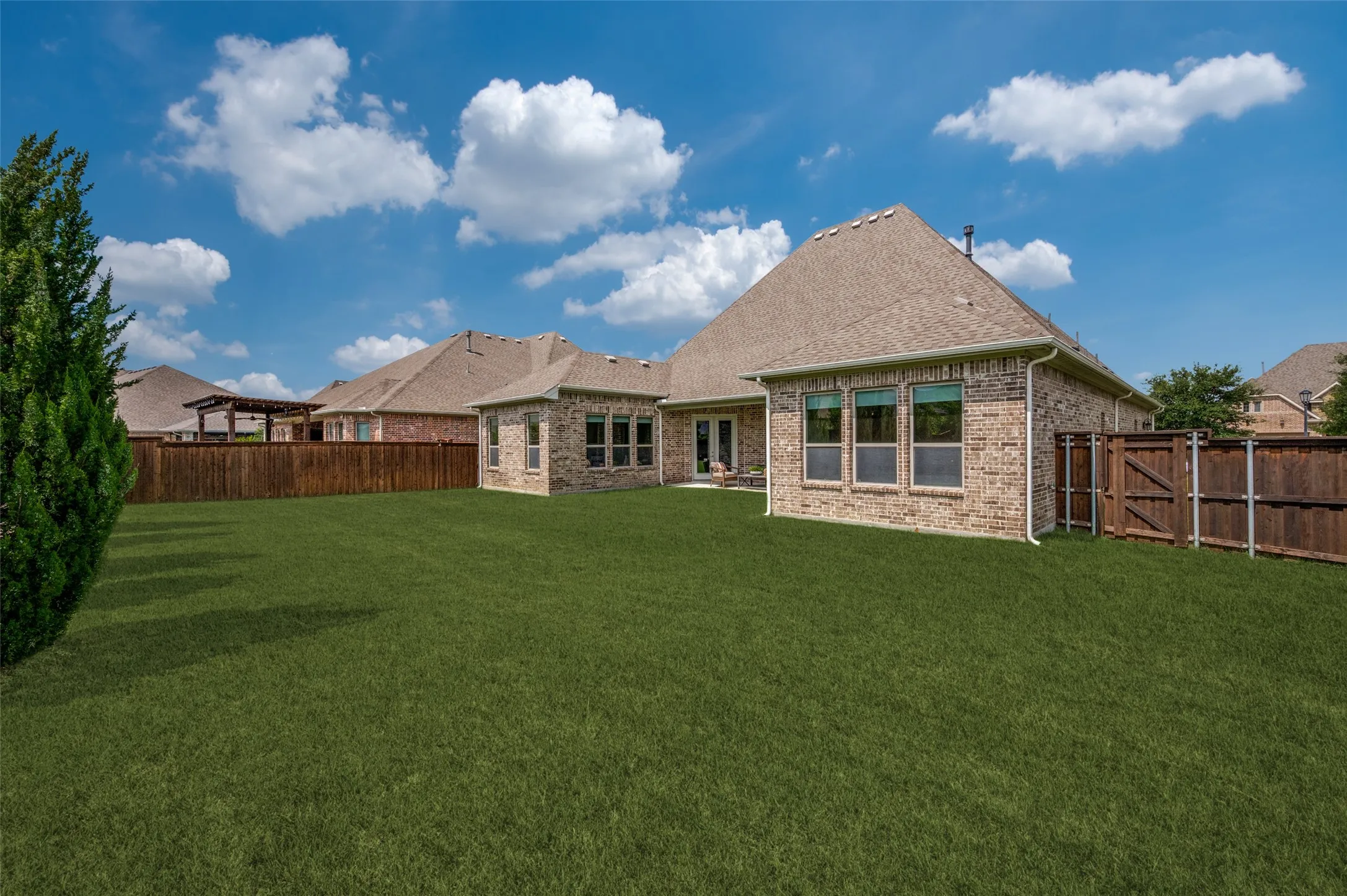 Expansive backyard with lush green space and plenty of room for a future pool or outdoor oasis.