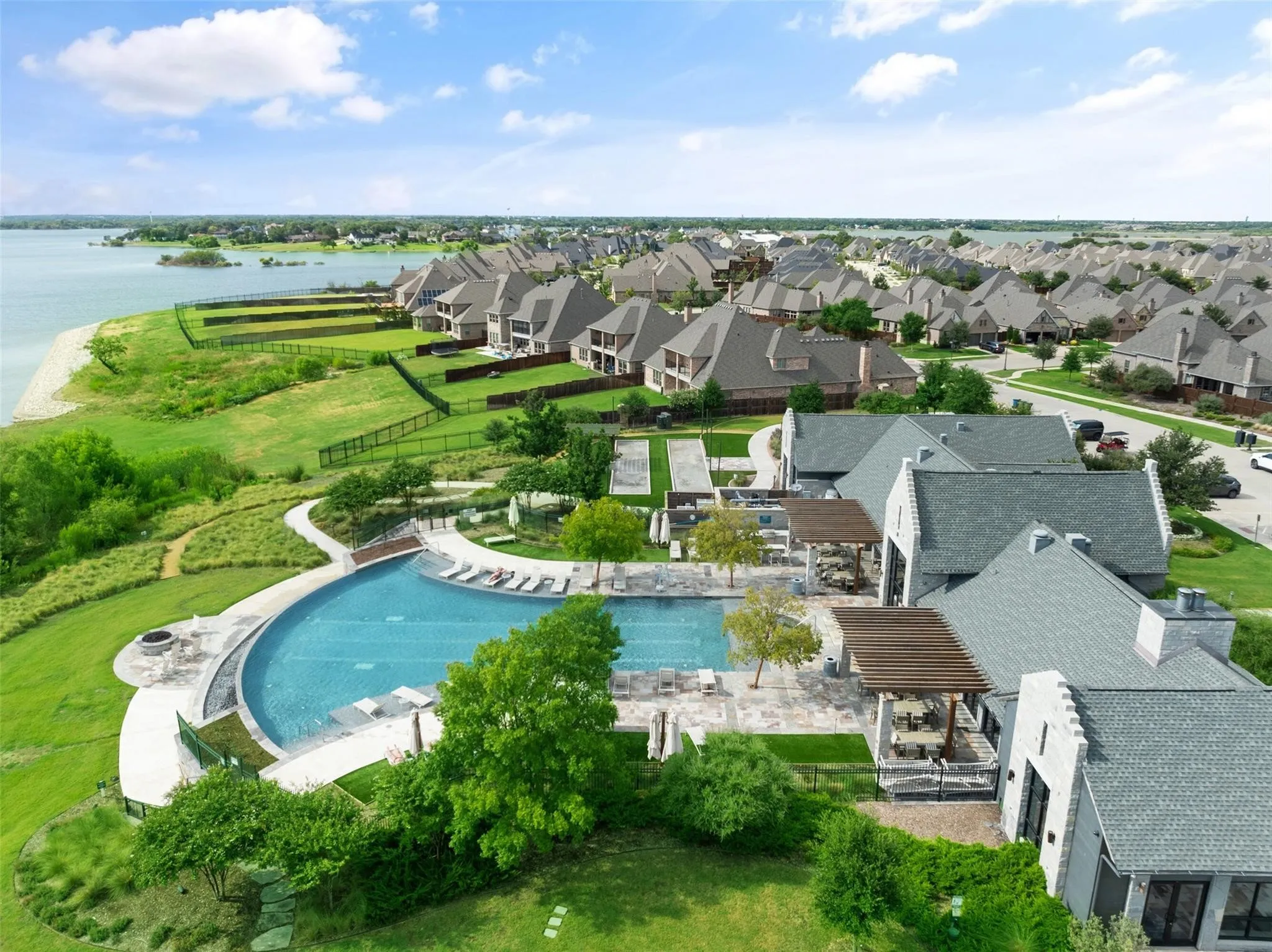 Resort-style community amenity center featuring an infinity-edge pool with breathtaking views of Lake Lewisville.